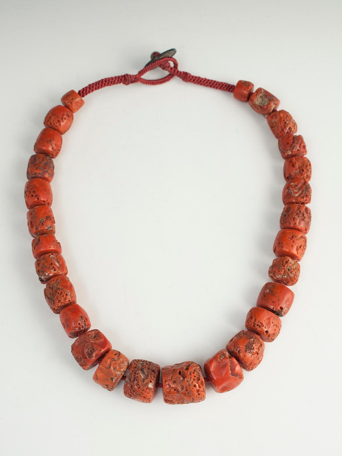 Large chunky Tibetan coral necklace

A beautiful, deep orange-red coral necklace strung on a contemporary crown-knotted cord. The clasp is an old Chinese coin and the beads are old Tibetan coral. The inner circumference measures 22