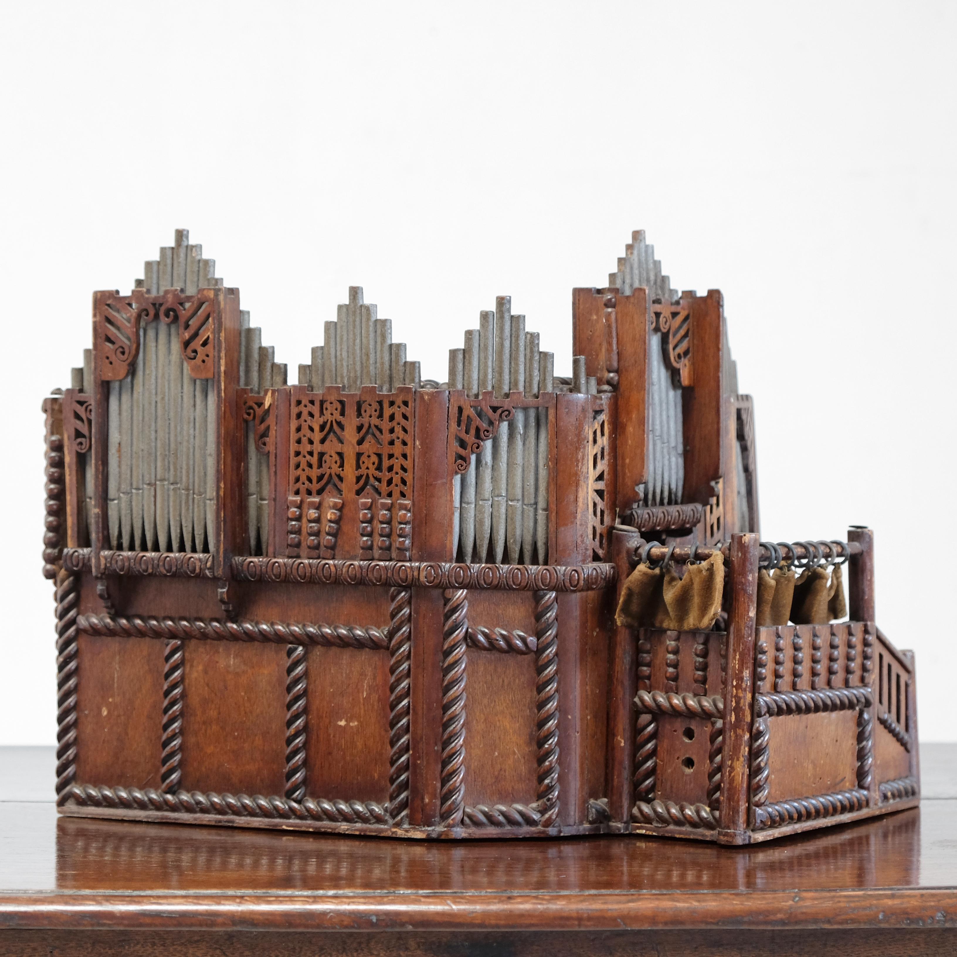 A charming scratch-built antique scale or architectural model of a large church or cathedral organ. Constructed in mixed timbers, it was originally used as a donation box - there is a coin slot in the top and internally there is the later addition