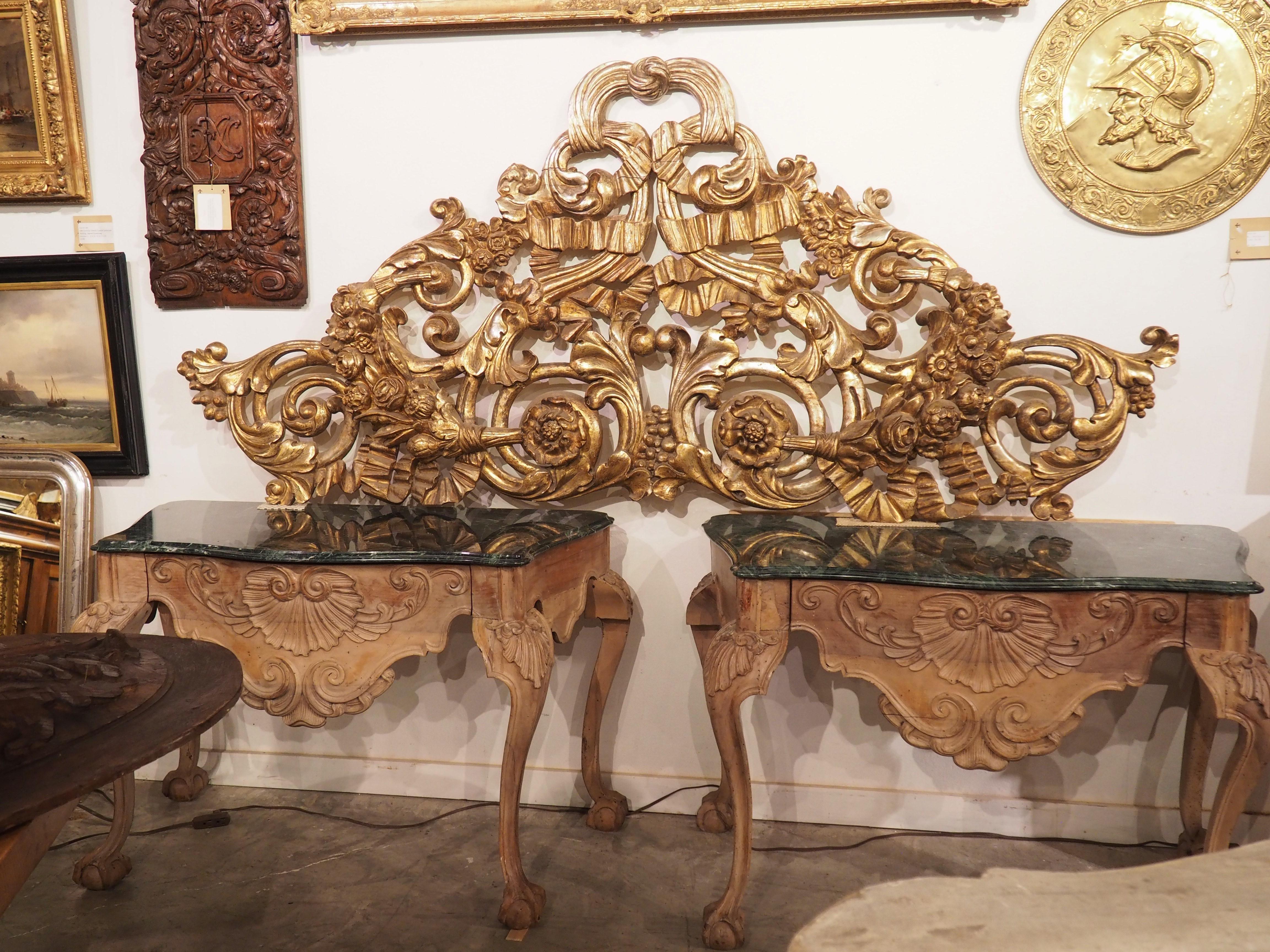 Hand-carved in Italy circa 1850, this very large giltwood architectural was finished using a process known as meccatura, which involves covering the silver gilding with a gold varnish. Time and wear to the gilding (which is normal for a piece of