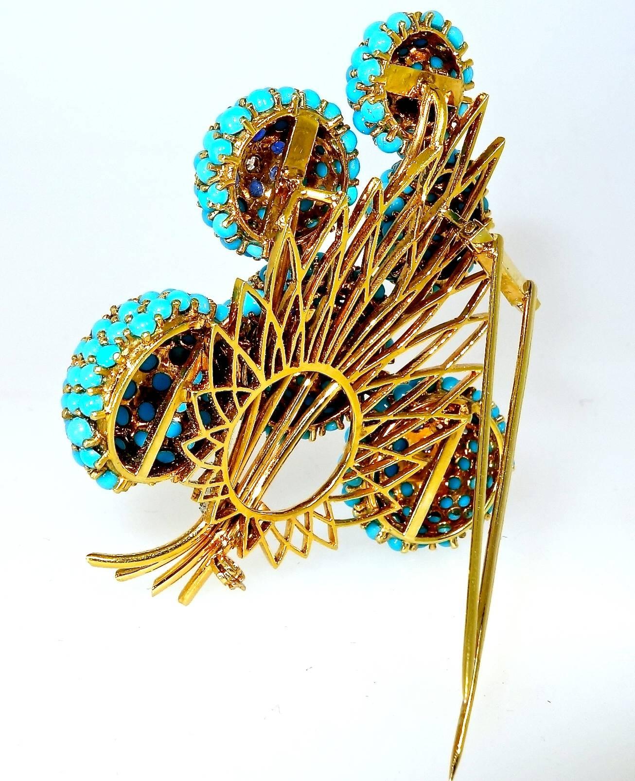 A robust 1960's dress clip with fine Persian turquoise, 16 European cut and modern white diamonds, weighing .60 cts., approximately.  There are 36 royal blue sapphires weighing 3.33 cts.  The piece weighs 55.95 grams.  This double clip brooch is 3.5