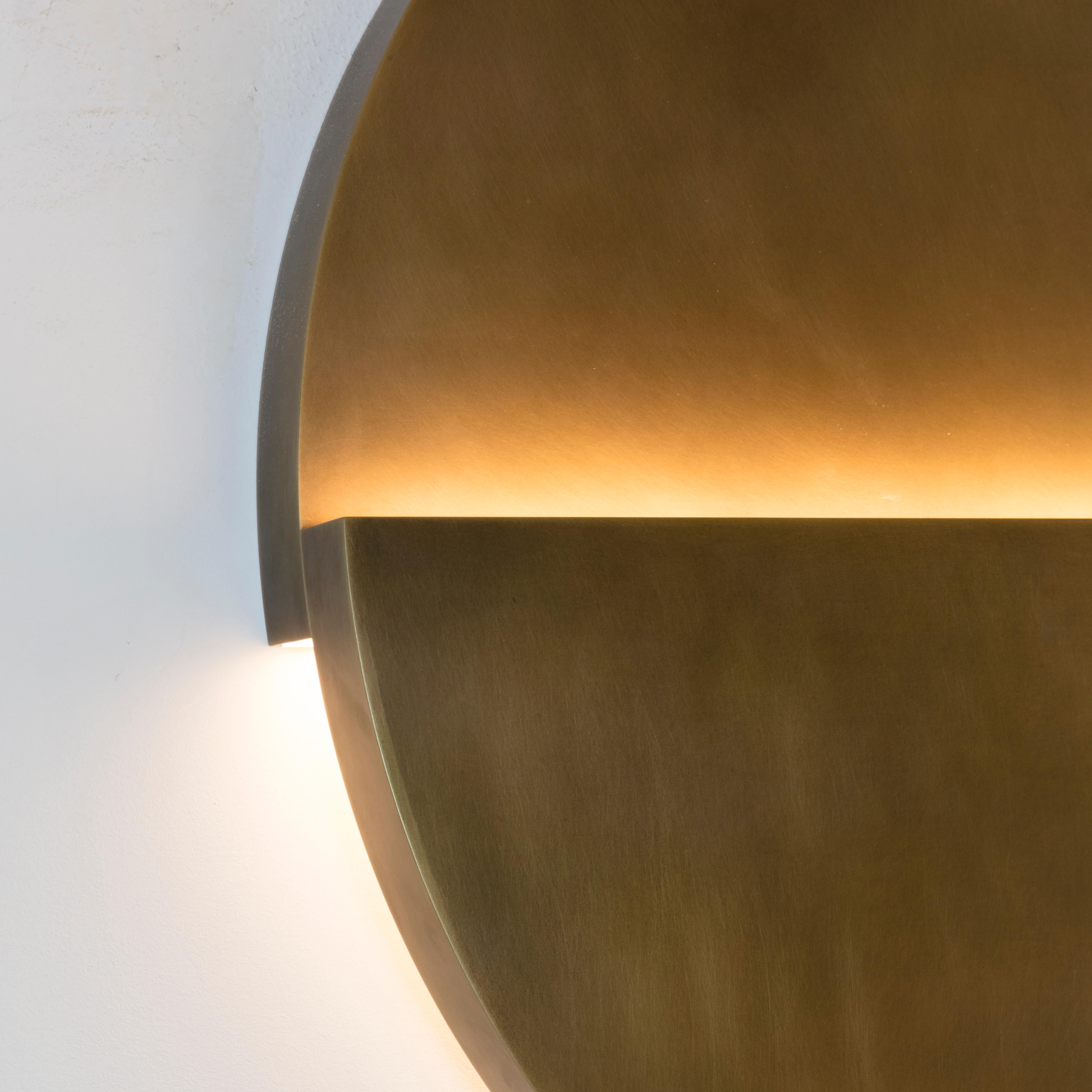 Part of the Cycladic Series, exploring the power of architecture brought to small scale. The circle sconce illuminates the purity, symbolism and intimate power of the circle: one of the most emblematic, elemental geometric forms expressed in both
