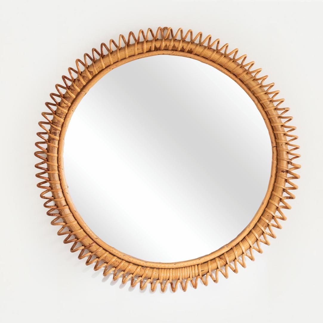 Beautiful large circular rattan mirror from Italy, 1960's. Unique design with spiral rattan detailing encompassing the mirror. Great size, perfect for bathroom or entryway. Nice vintage condition with original coloring.