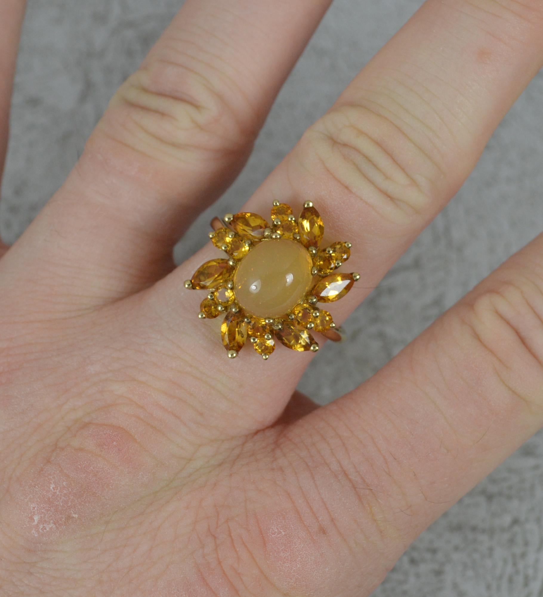 A superb 9 carat gold and citrine cluster cocktail ring.
Set with an oval cabochon citrine to centre in four claw setting. Surrounding are many marquise and round cut citrines creating quite a statement.
18mm x 20mm cluster head.

Condition ; Very