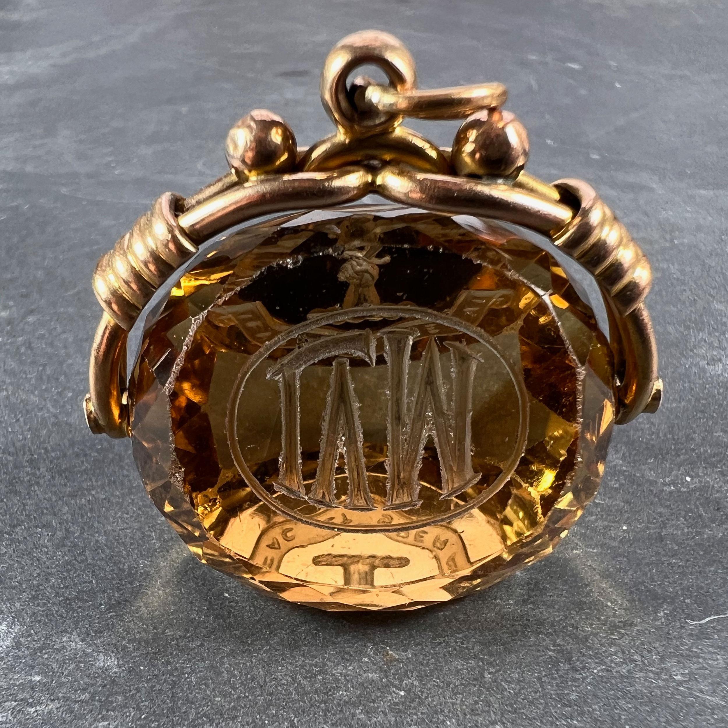 A large yellow gold charm pendant designed as a spinning citrine fob engraved to one face with a monogram of LVM, to another face with the crest and motto ‘FAC et SPERAI’ (Do and Hope), being that of the Matheson Clan. Hallmarked for 9 karat gold,