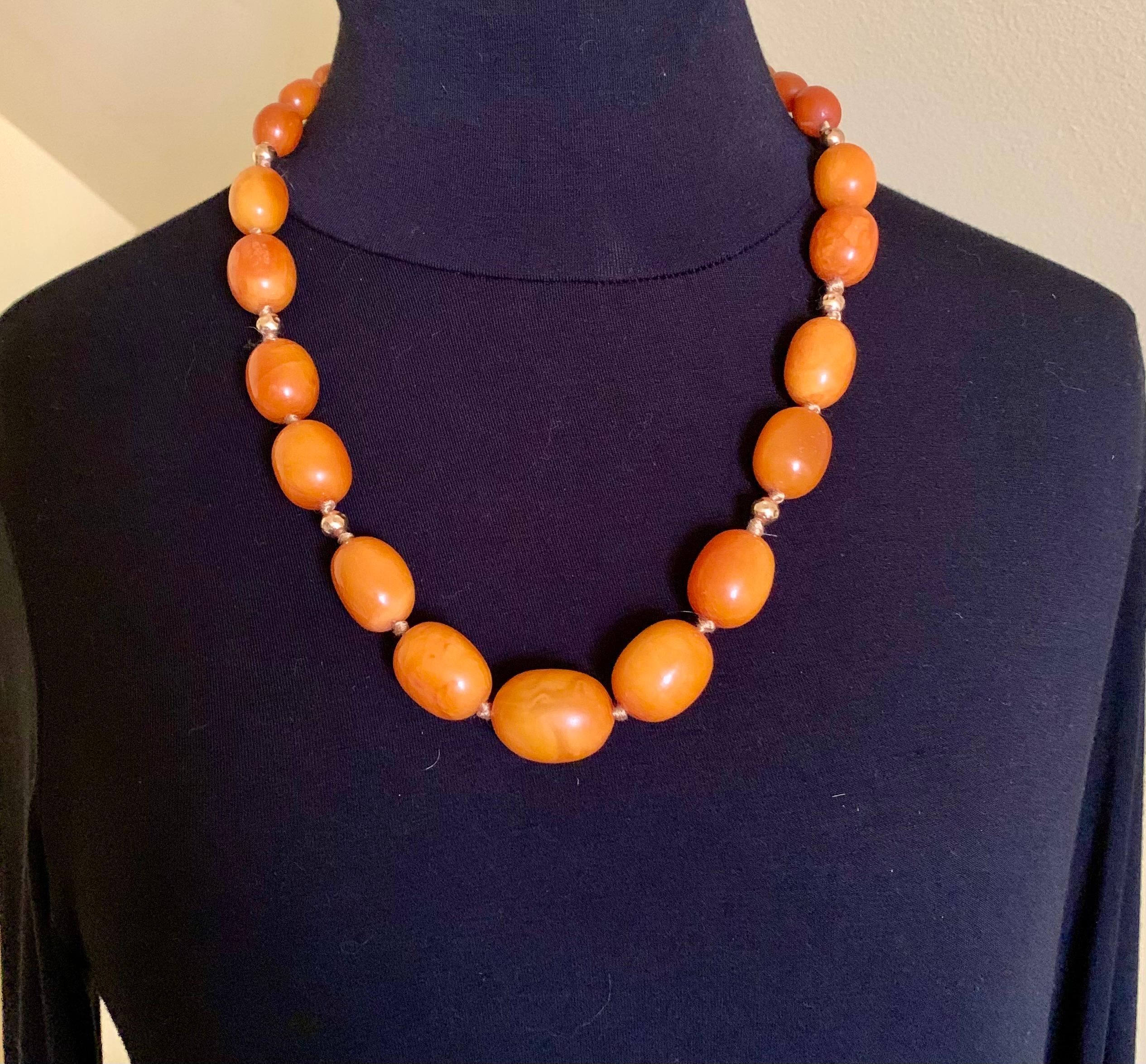 Substantial 72.6 gram natural yellow amber and 14K yellow gold bead necklace composed of twenty seven attracive oval amber beads with 14K yellow gold spacer beads. Excellent color with desirable variegation refered to as egg yolk. 
Amber beads: 29mm