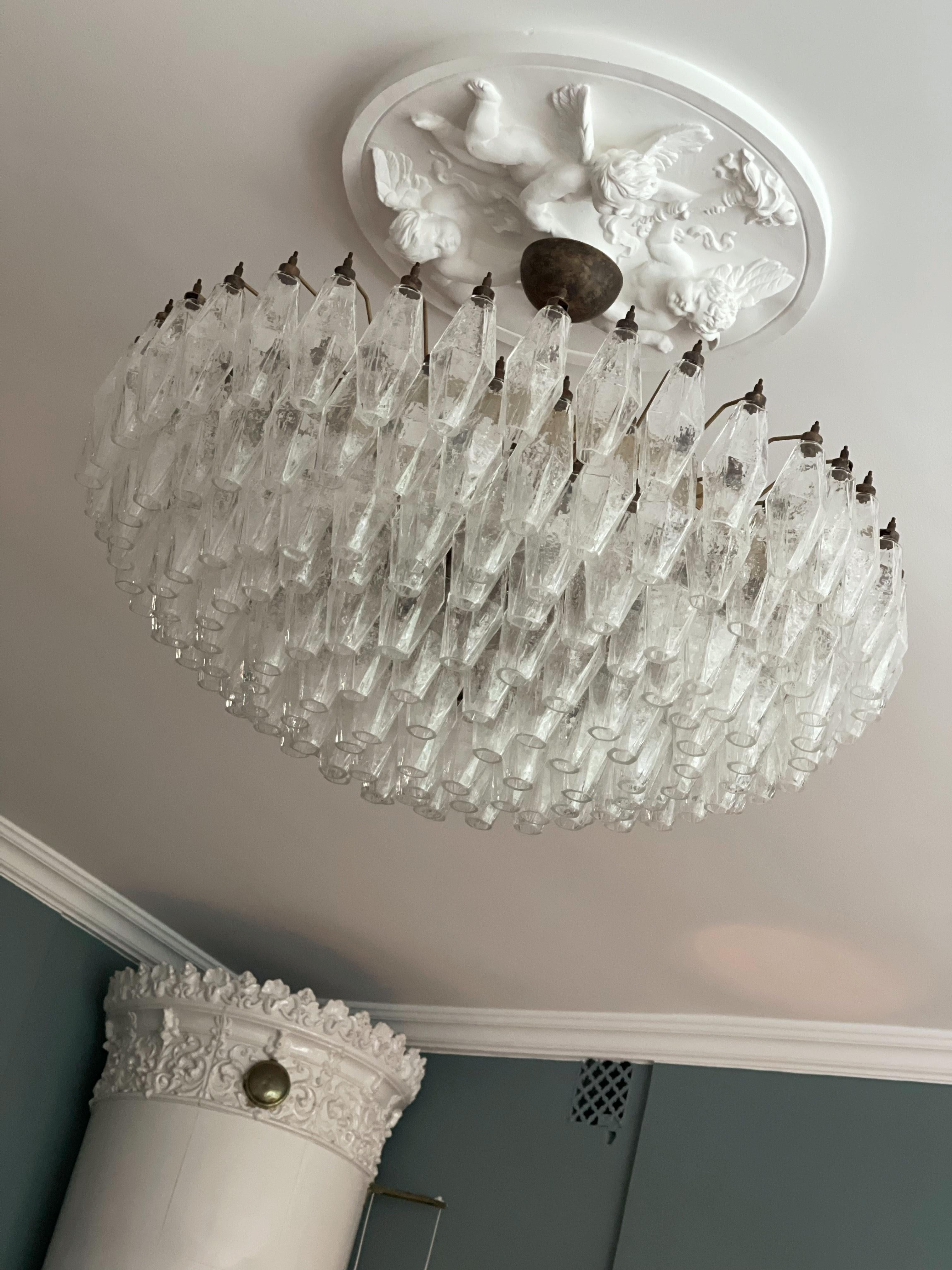 Riesiger Statement Murano Kronleuchter im Stil von Scarpa mit wunderschönen mundgeblasenen Poliedri Prismen.
Lampe Struktur in Metall, die in einem schönen braun-bronze Farbton lackiert ist.
Der Kronleuchter besteht aus 181 transparenten Glasprismen