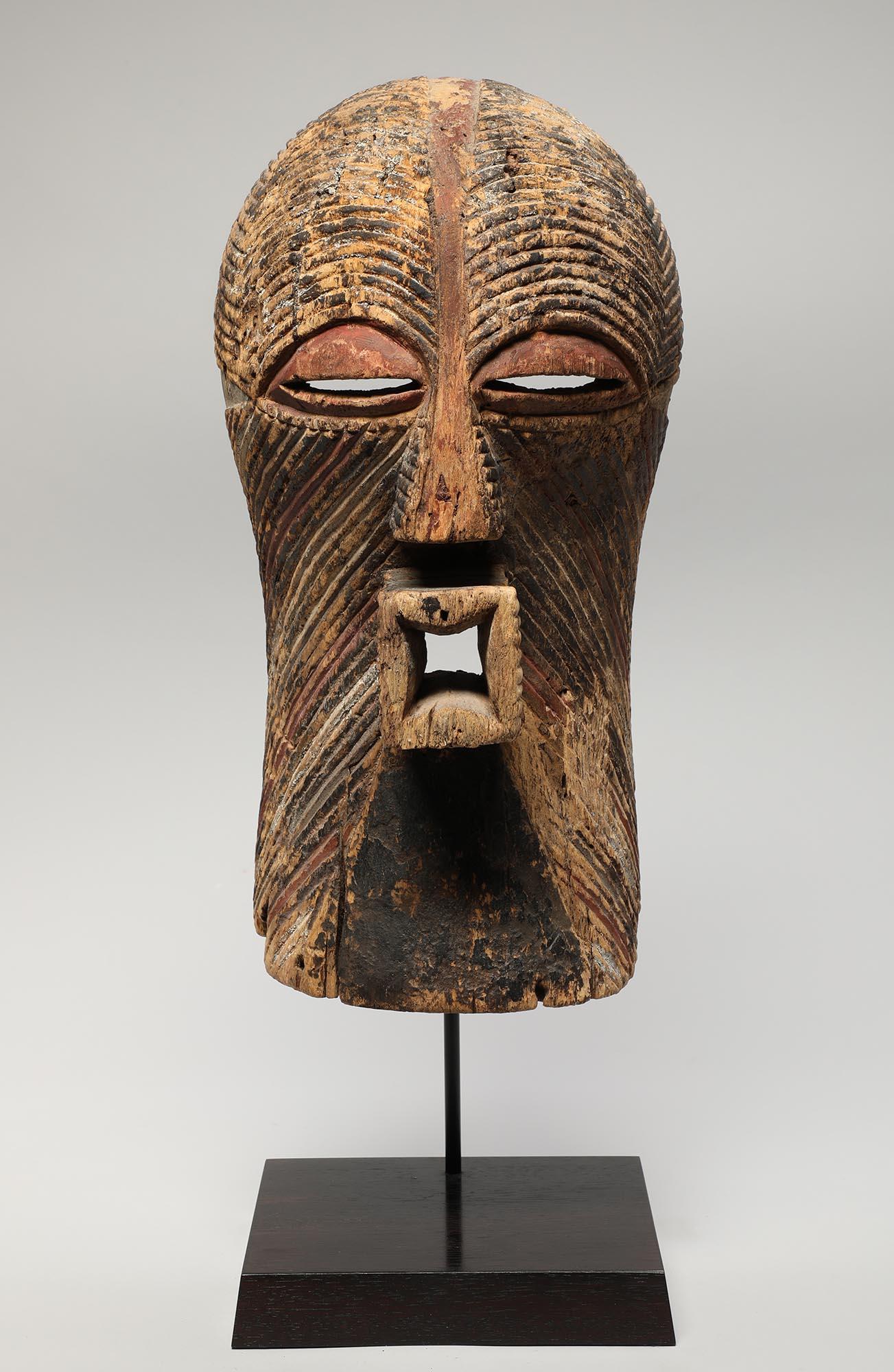 A fine and impressive early large Classic Songye Kifwebe mask with weathered and eroded surface, finely carved incised design and traces of pigments. From the collection of Woods Davy, (whose collection is published in 