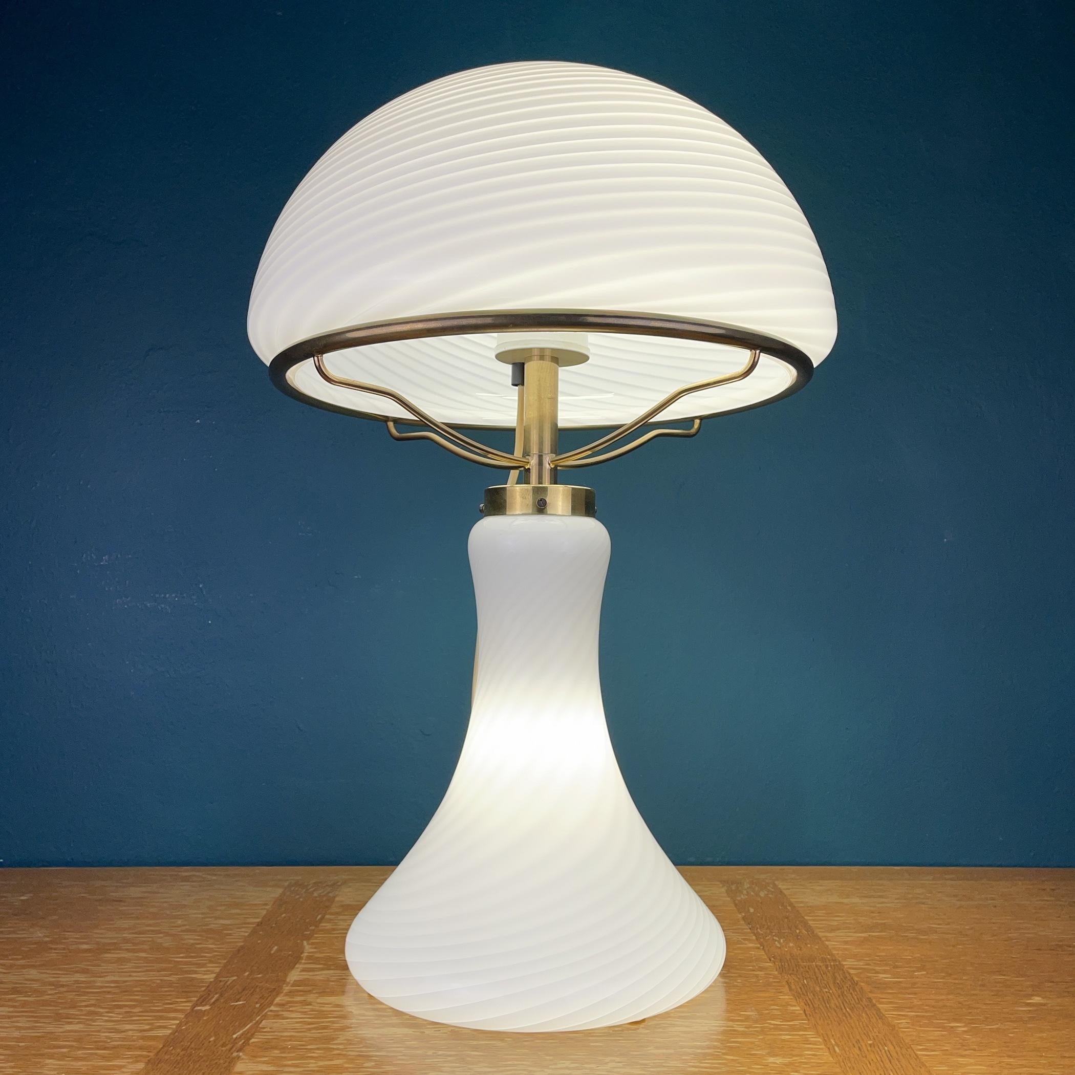 Huge magnificent swirl Murano glass table lamp Mushroom made in Italy in the 1970s. The beauty of the classic swirl glass makes this lamp a pleasure to look at. It has three light bulbs above and one light bulb in the base. Upper and lower bulbs can