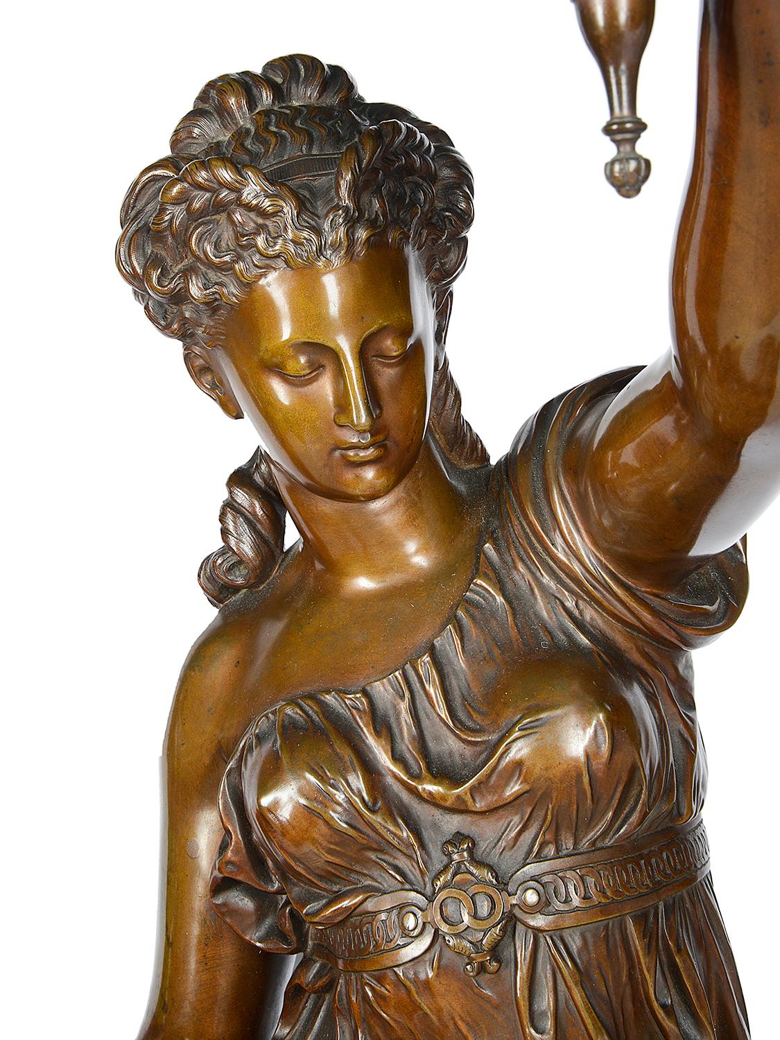 A wonderful quality pair of large 19th century French patinated bronze classical female statues / lamps. Each depicted beautiful maidens dressed in flowing drapes, mounted on carved giltwood pedestals. Measures: 170cm (67").