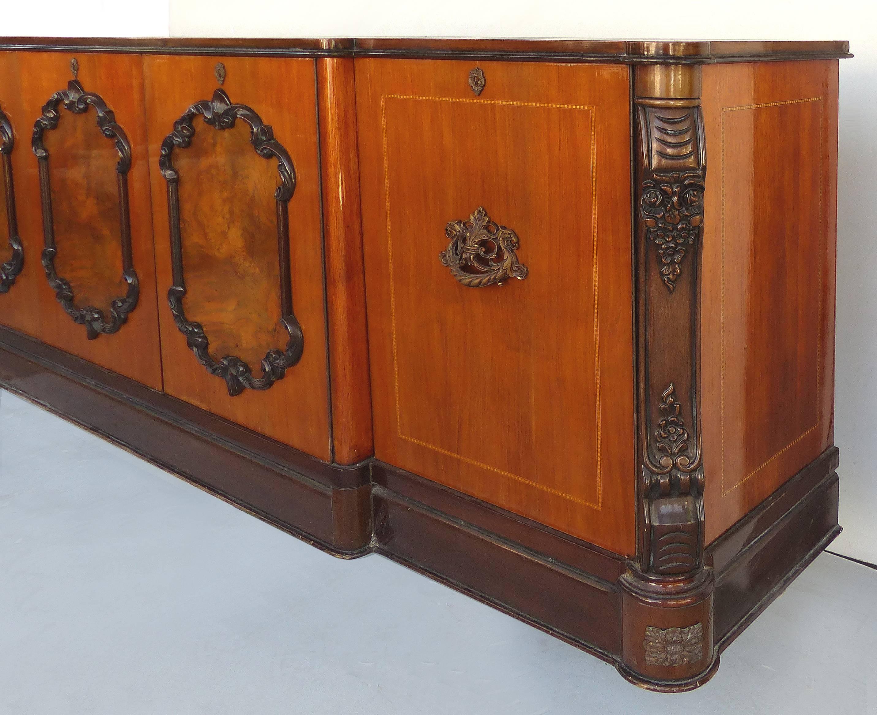 Mahogany, Walnut, Satinwood Italian Sideboard Credenza

Offered for sale is a fine-quality Italian classical sideboard/credenza made of mahogany and walnut with satinwood banding and ebonized wood-applied decorative molding. Mahogany doors with