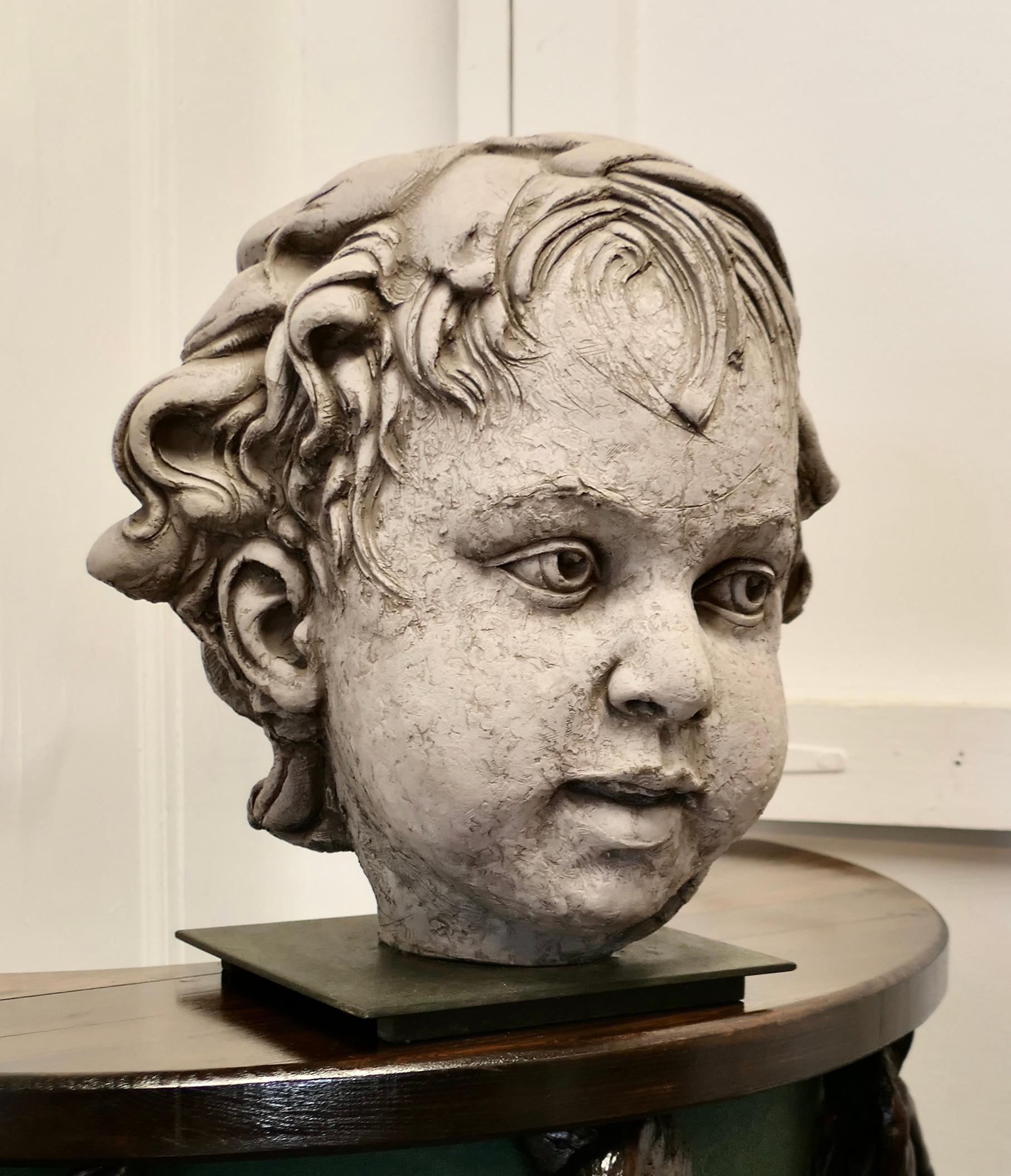 Large Clay Bust of a Child by Philippe Seené, 2004 set on Bronze  
 
Life size signed bust of a cherubic child, the bust is made in clay and is set into a bronze plinth, the signature on the back is “Ph Seené, 2004”
This piece was found in Brittany 