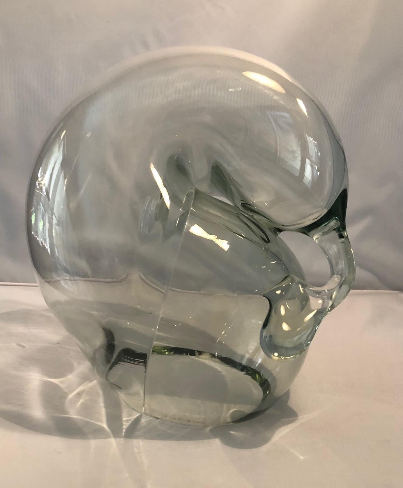 Large clear art glass orb sculpture by John Bingham, circa 1980s. This hand blown glass orb sculpture has a biomorphic free form design and is in very good condition with no chips or cracks. The piece is approximately 10