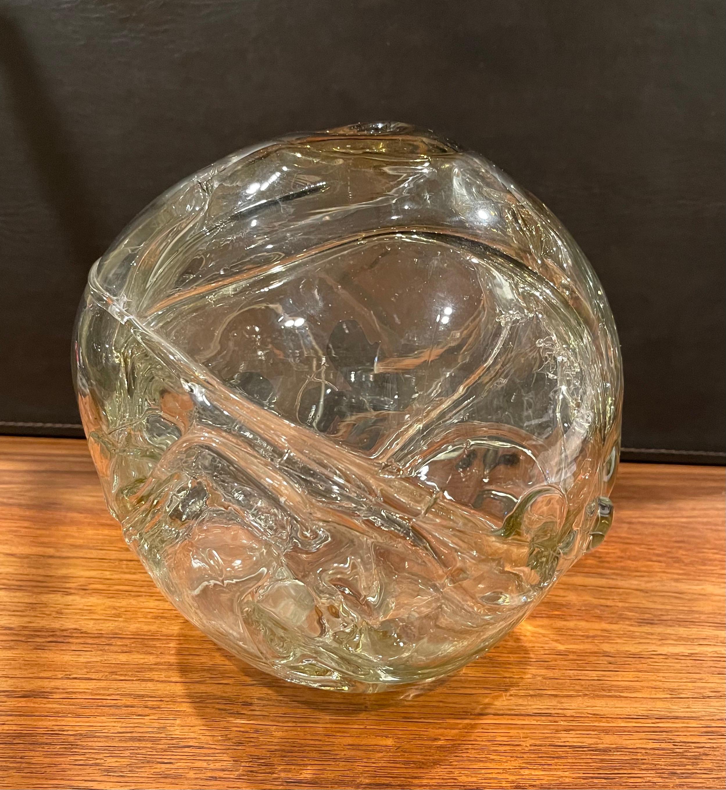 Very early large freestyle clear art glass orb vase by Peter Bramhall, circa 1972. This hand blown glass orb sculpture has a biomorphic free form design and is in very good condition with no chips or cracks. The piece is approximately 8.5