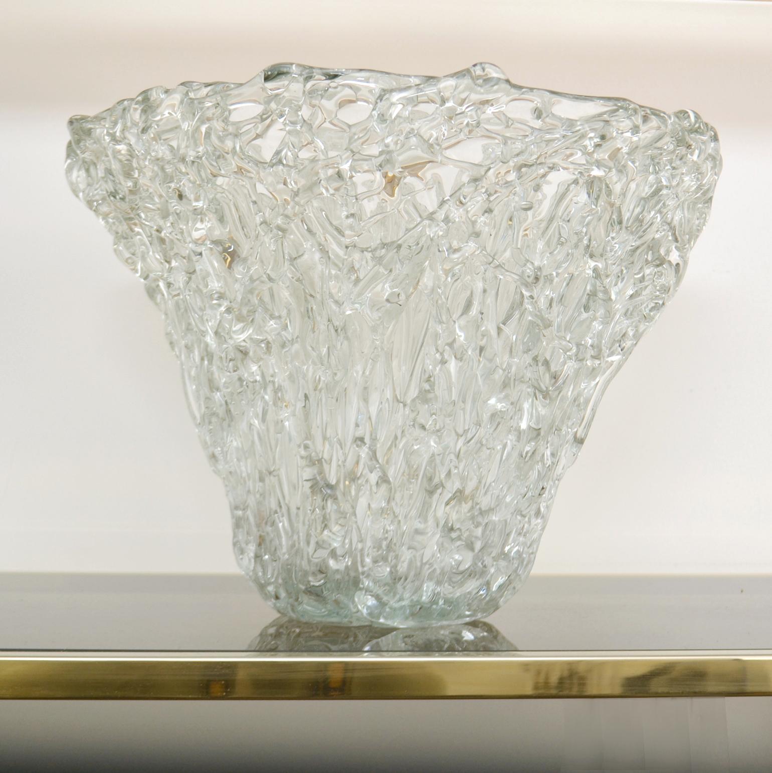 The 1980's coned shaped art glass vessel was hand blown by Romanian master glass maker Mihai Topescu (1956) and is signed inside of the bowl. The clear glass is overlaid with trails of snake shaped in clear glass dripped over the surface of the