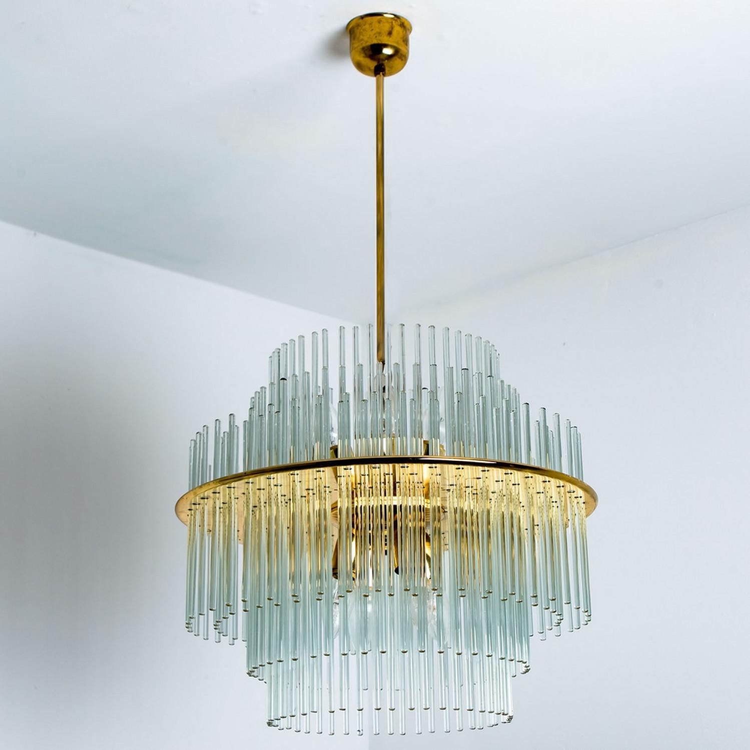 Linee pulite che si integrano con tutti gli arredi. Splendida lampada di fascia alta di Sciolari. Il vetro sospeso con dettagli in ottone conferisce al pezzo un aspetto elegante che rifrange la luce, riempiendo la stanza con una luce morbida e