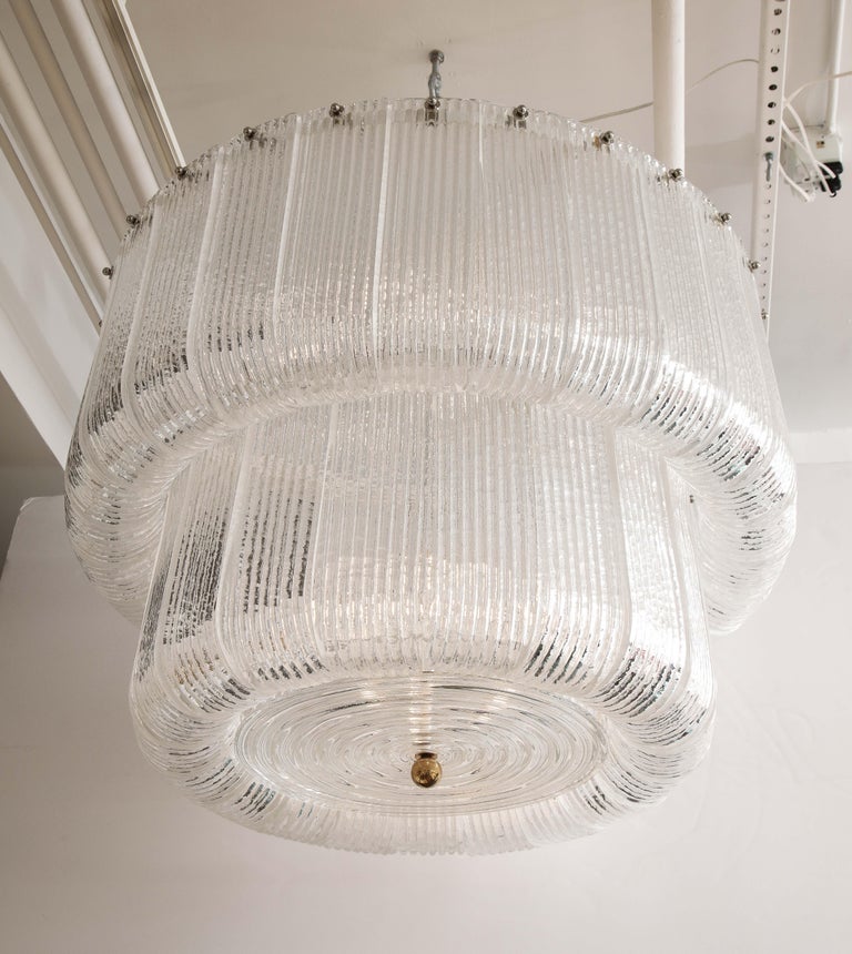 Large clear Murano glass round chandelier in the manner of Barovier & Toso, Italy, 2021. This Italian chandelier was hand-casted with stamped and textured clear Murano glass and designed after a Barovier and Toso 1950s model. Individually handmade
