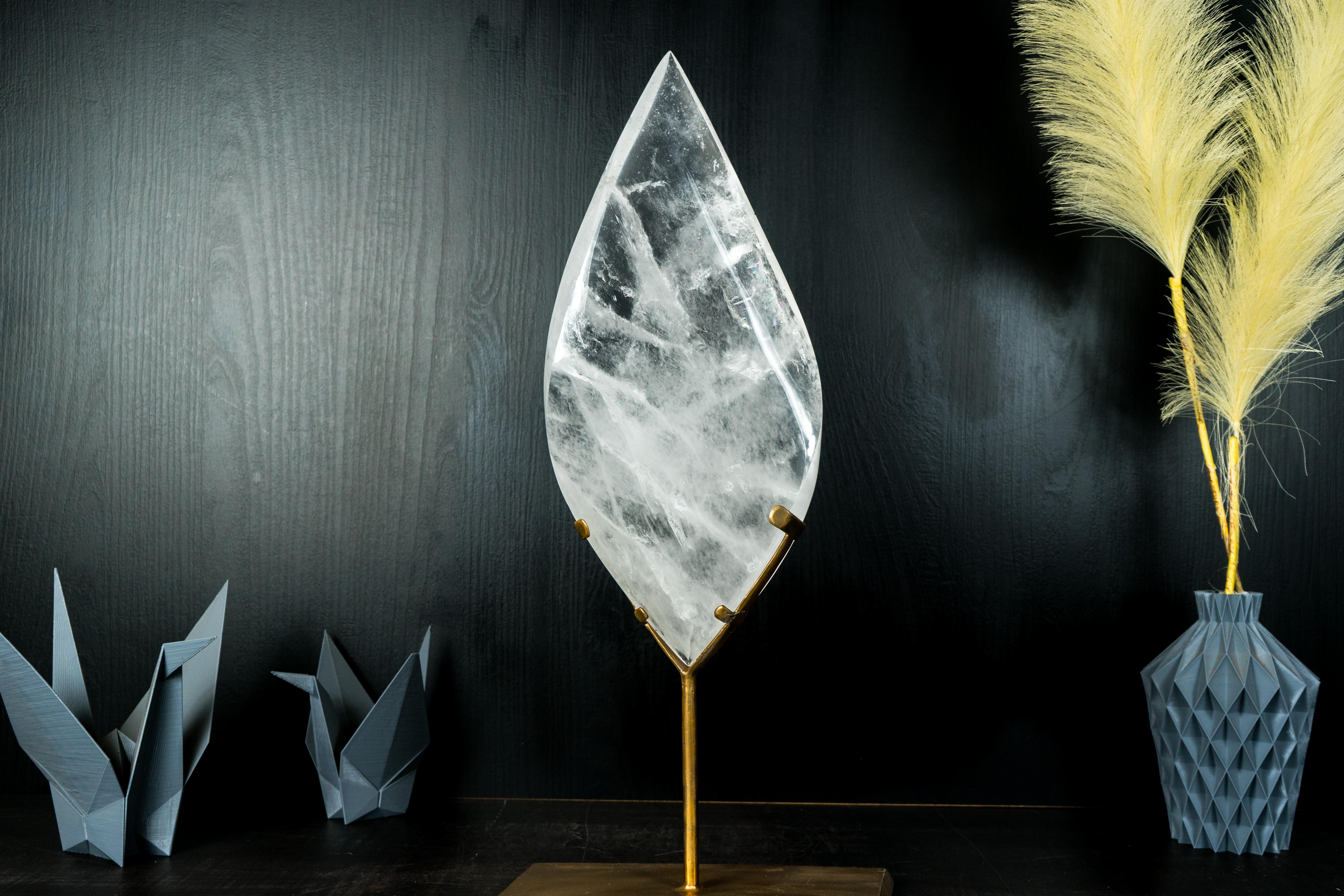 With gorgeous aesthetics and expert carving, this is an exquisite quartz flame sculpture. Its unique shape, combined with the natural inclusions and brilliant reflections, makes it a standout piece for any collection or a stunning decorative element