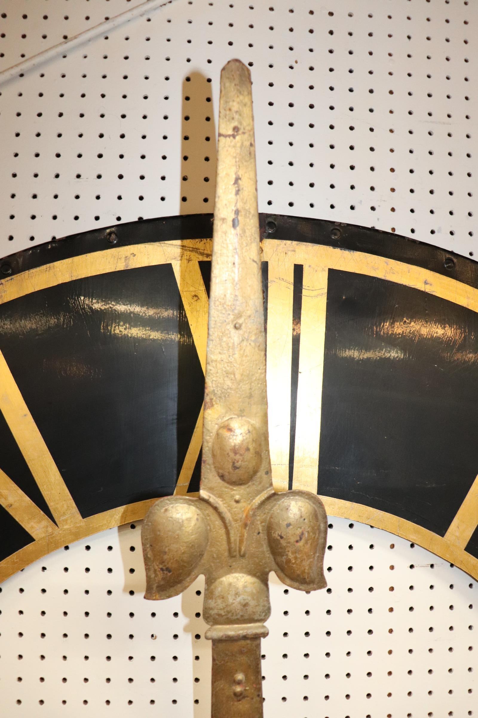 A large clock face measuring over 5 feet in diameter, from a clock-tower or church, 19th century, with gilded Roman numerals.