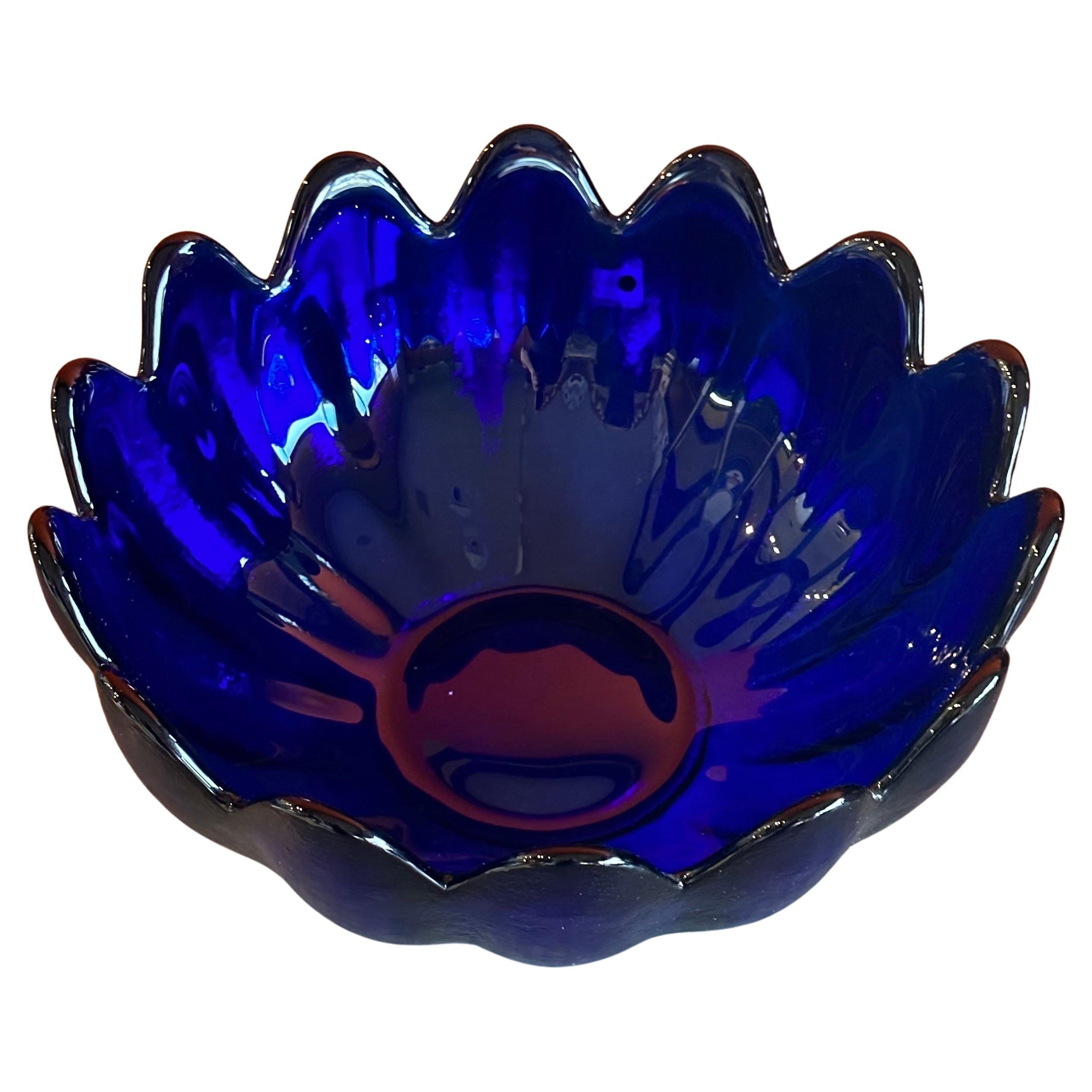 Large cobalt blue art glass scalloped edge petal bowl by Blenko Glass, circa 1990s.  This beautiful piece is signed (foil Blenko sticker attached) and conceptualizes the beauty and glow of cobalt blue handblown glass and texture.  Beautiful piece of