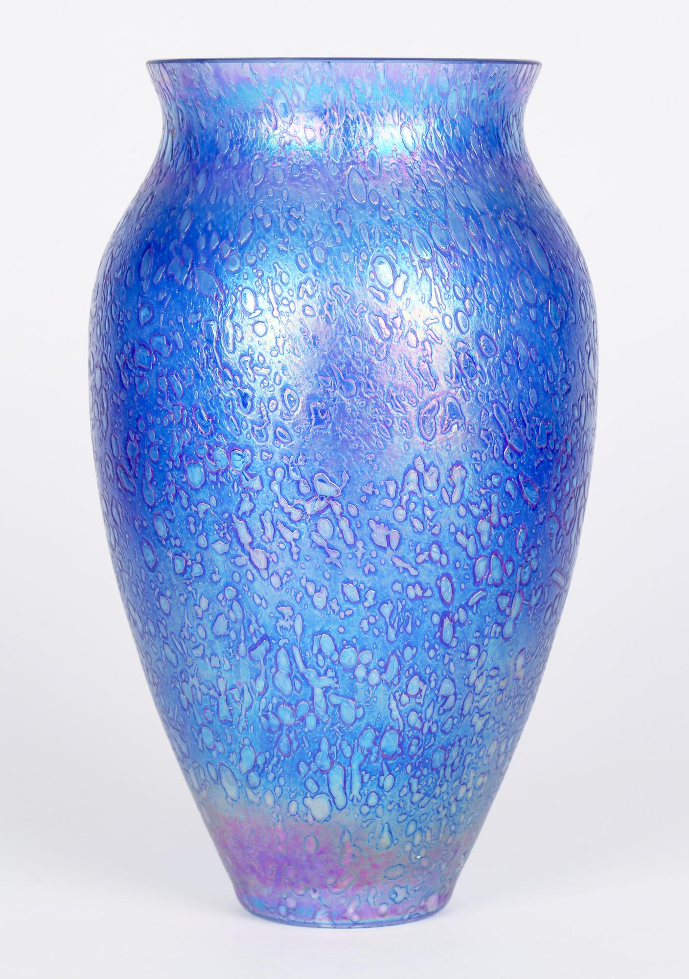 Large quality blown art glass vase decorated with a cobalt blue iridescent textured pattern probably Heron or Czech and dating from the 20th century. This large bulbous shaped vase has a narrow round foot with a slightly pinched neck and short