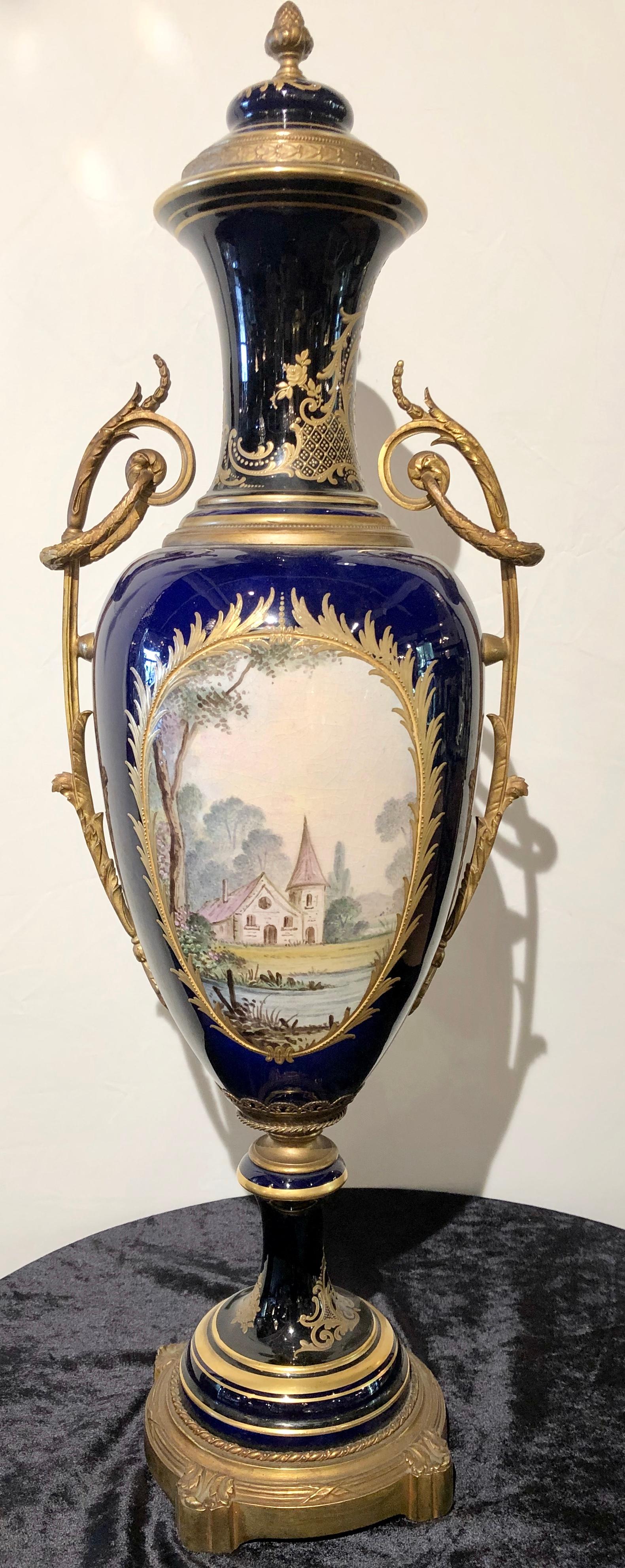Large cobalt blue pictorial Sevres vase with lid. The Manufacture nationale de Sèvres is one of the principal European porcelain manufactories. It is located in Sèvres, Hauts-de-Seine, France. It is the continuation of Vincennes porcelain, founded