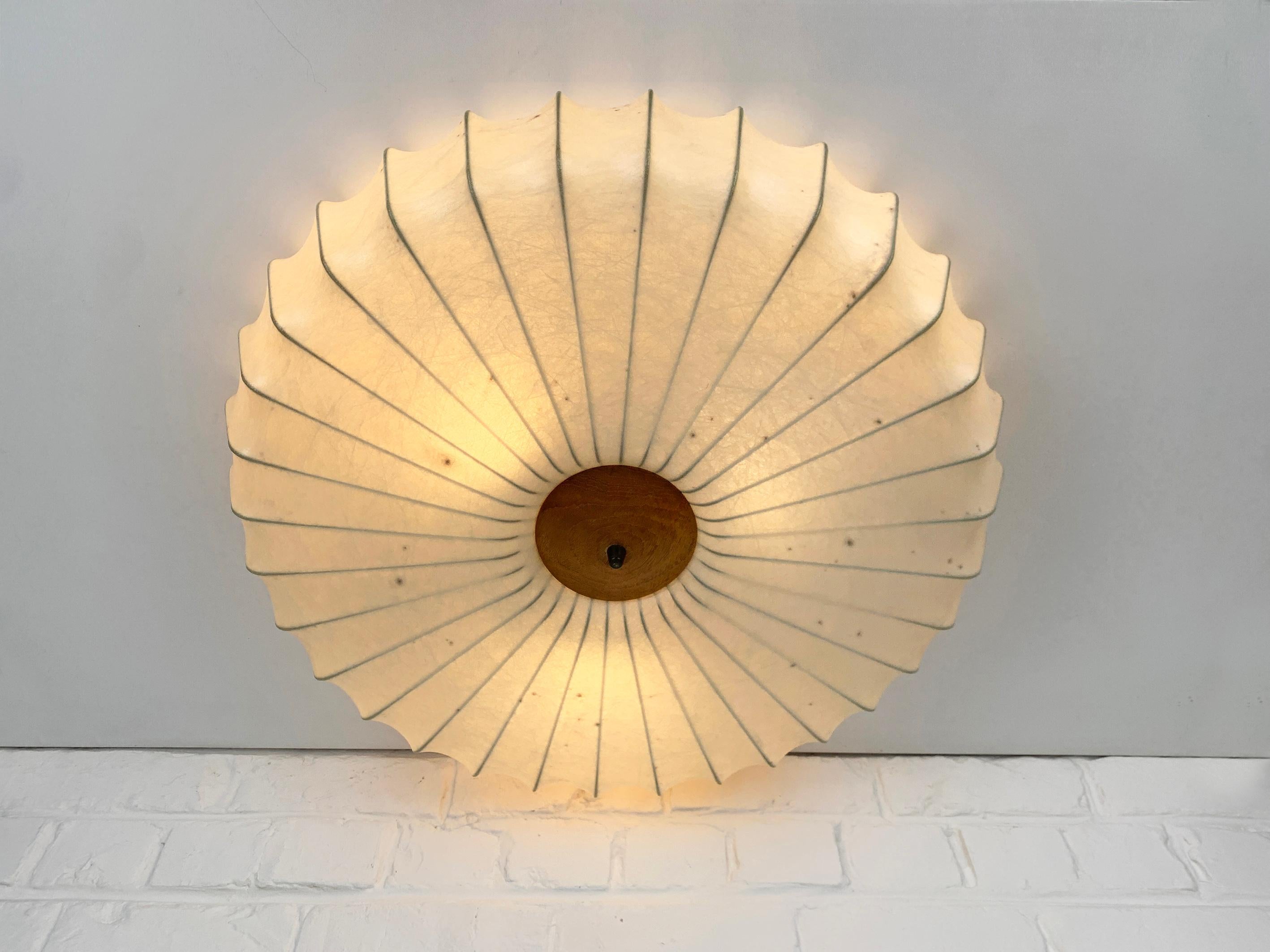 Cocoon lamp, design by Friedel Wauer. Manufactured by Goldkant Leuchten, Germany in the 1960s.

A thin steel framework covered with sprayed resin gives a Fiberglass look. The translucent resin gives a beautiful soft light effect. The central fixing