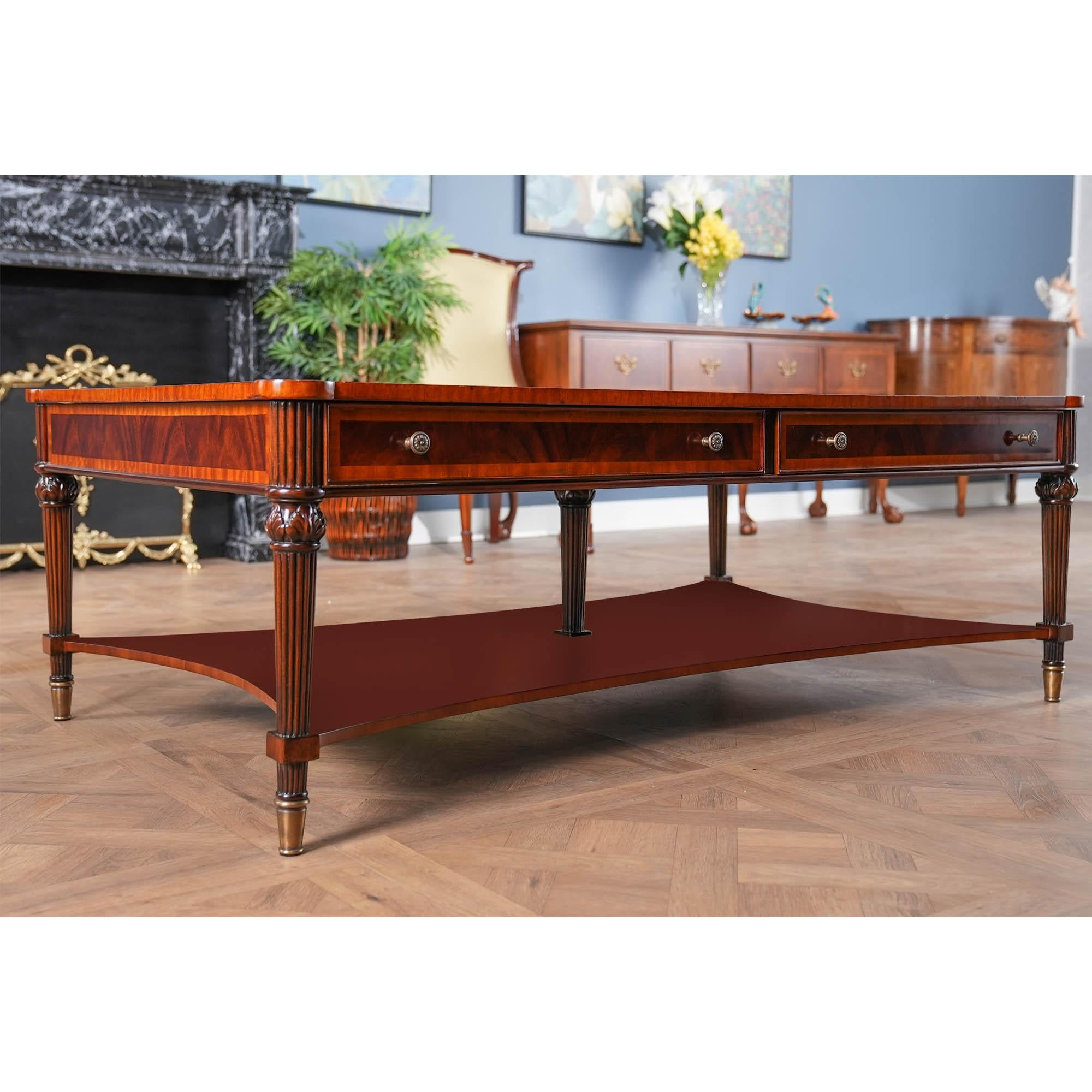 A Large Coffee Table from Niagara Furniture with all of the bells and whistles including four drawers, reeded legs, solid brass capped feet and cookie shaped, rounded corners. Great quality construction and attention to detail make this a