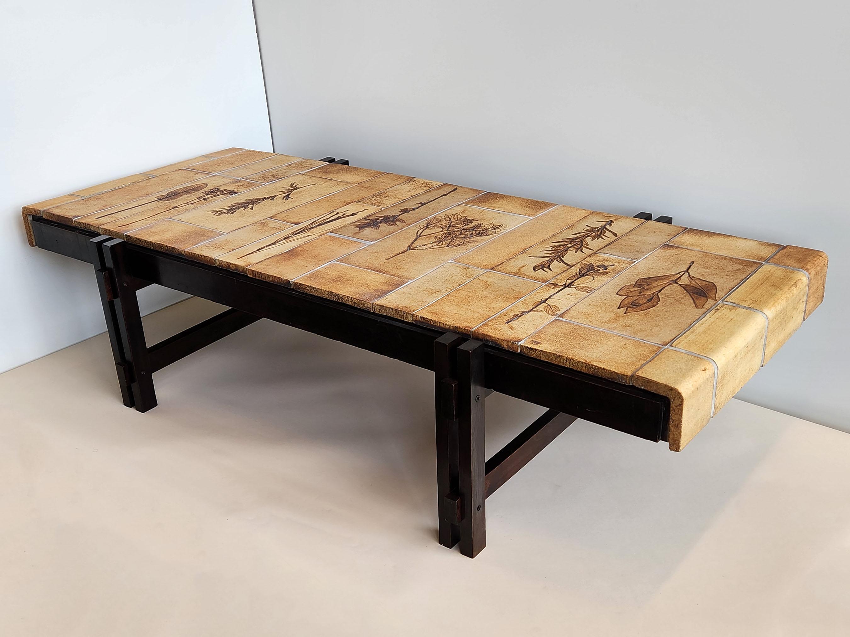 Very large coffee table with the famous Roger Capron Garrigue tiles, designed from 1968 to 1982. 

The handcrafted Garrigue tiles were produced by a technique in which real leaves were pressed into the clay and, during firing, disintegrated,