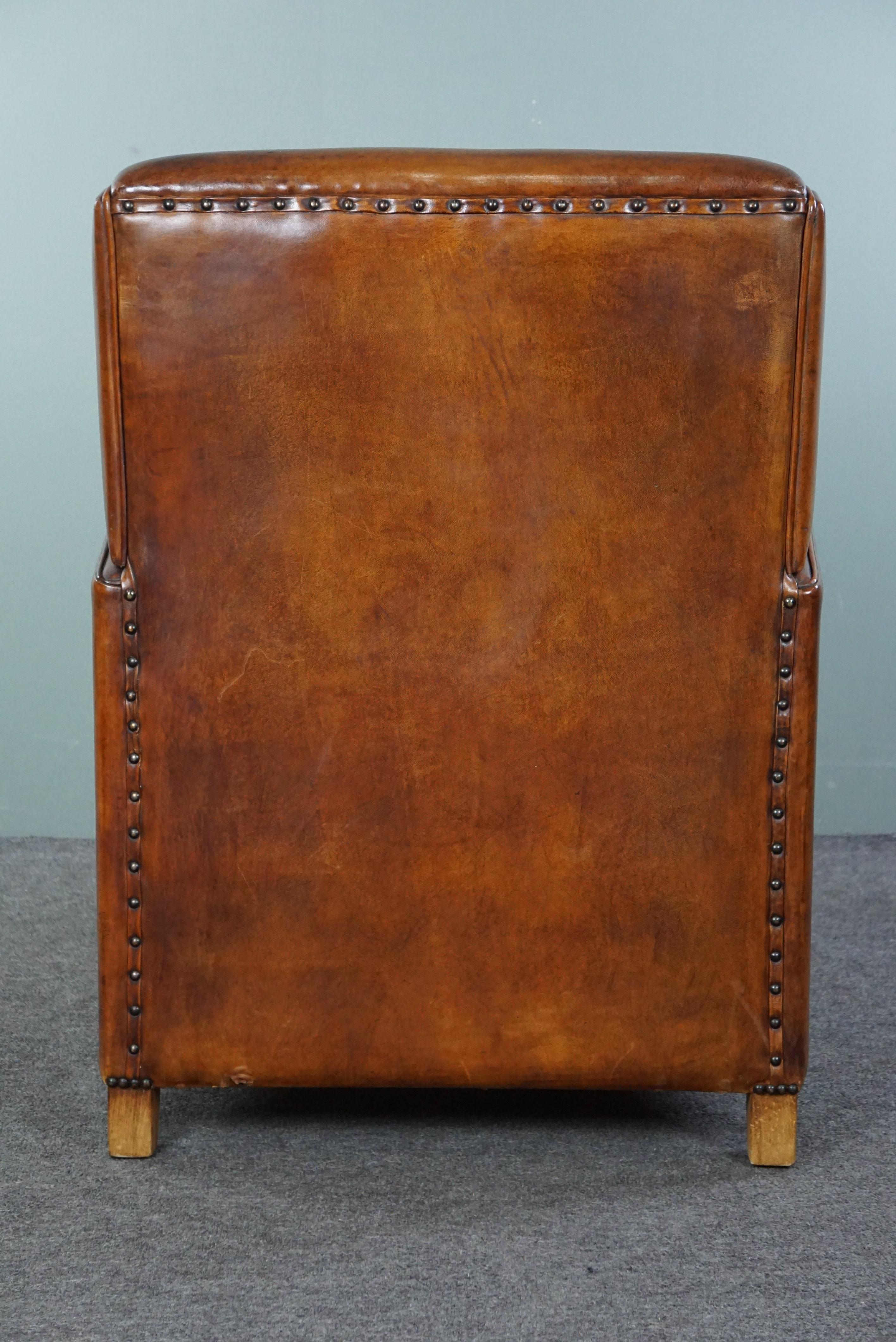 Late 20th Century Large cognac-colored sheep leather armchair in good condition with a sleek desig For Sale