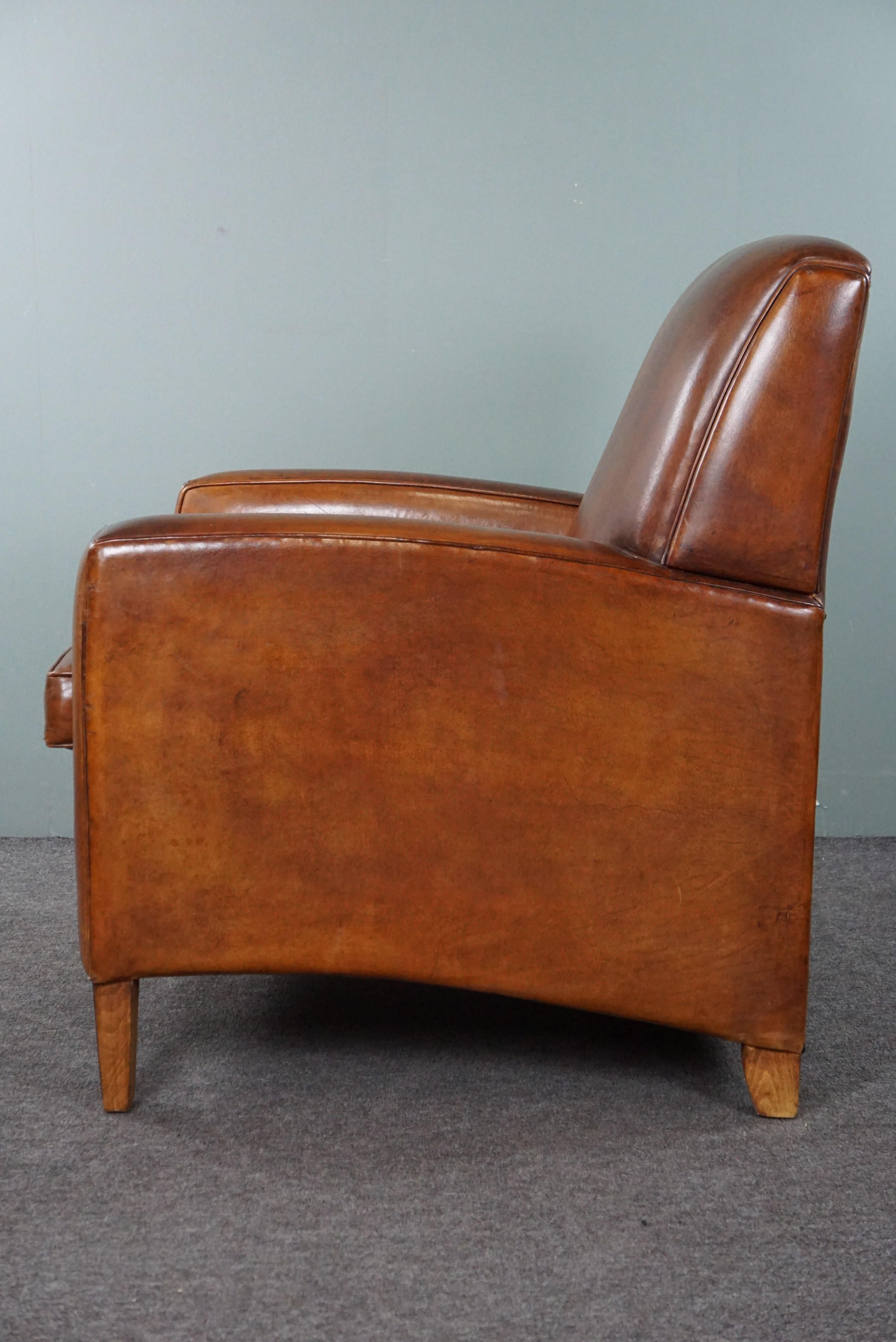 Leather Large cognac-colored sheep leather armchair in good condition with a sleek desig For Sale
