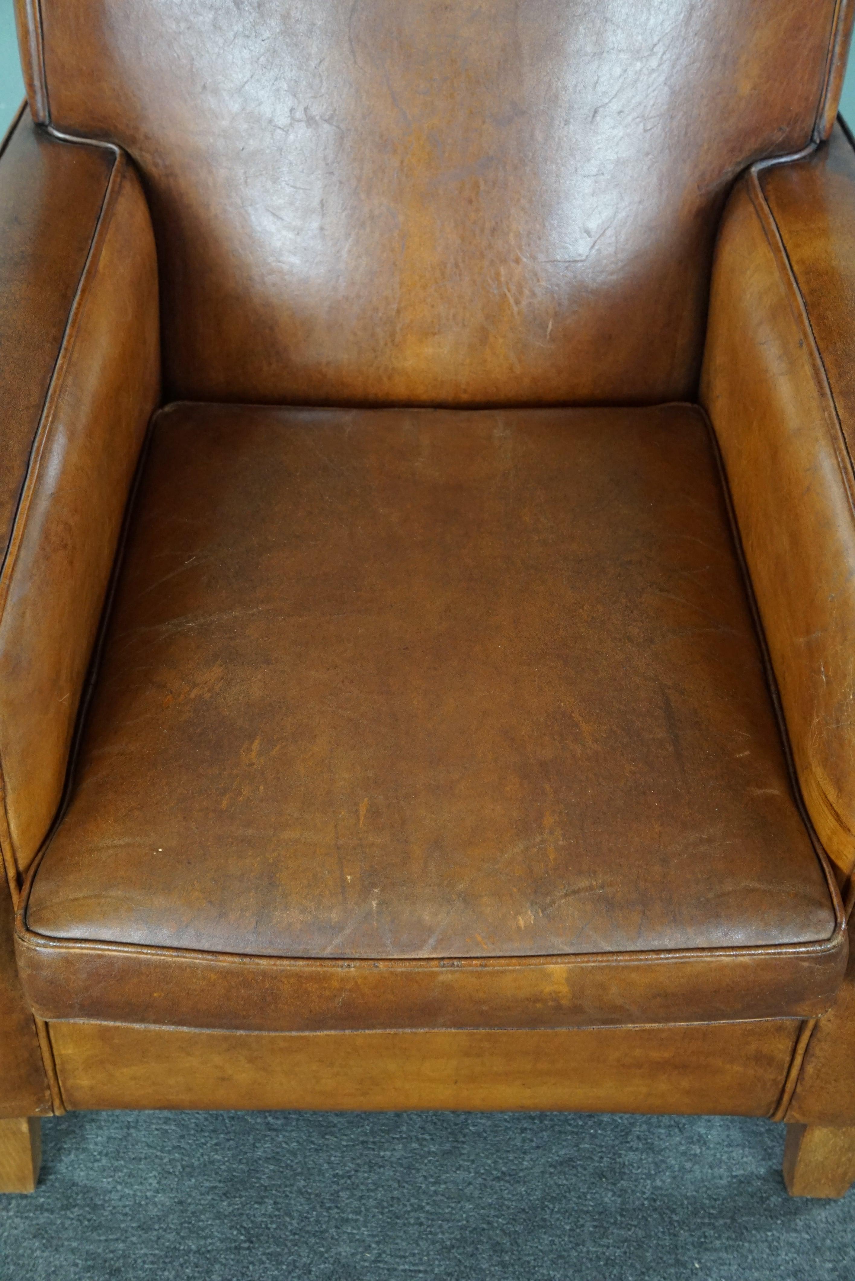 Large cognac-colored sheep leather armchair in good condition with a sleek desig For Sale 1