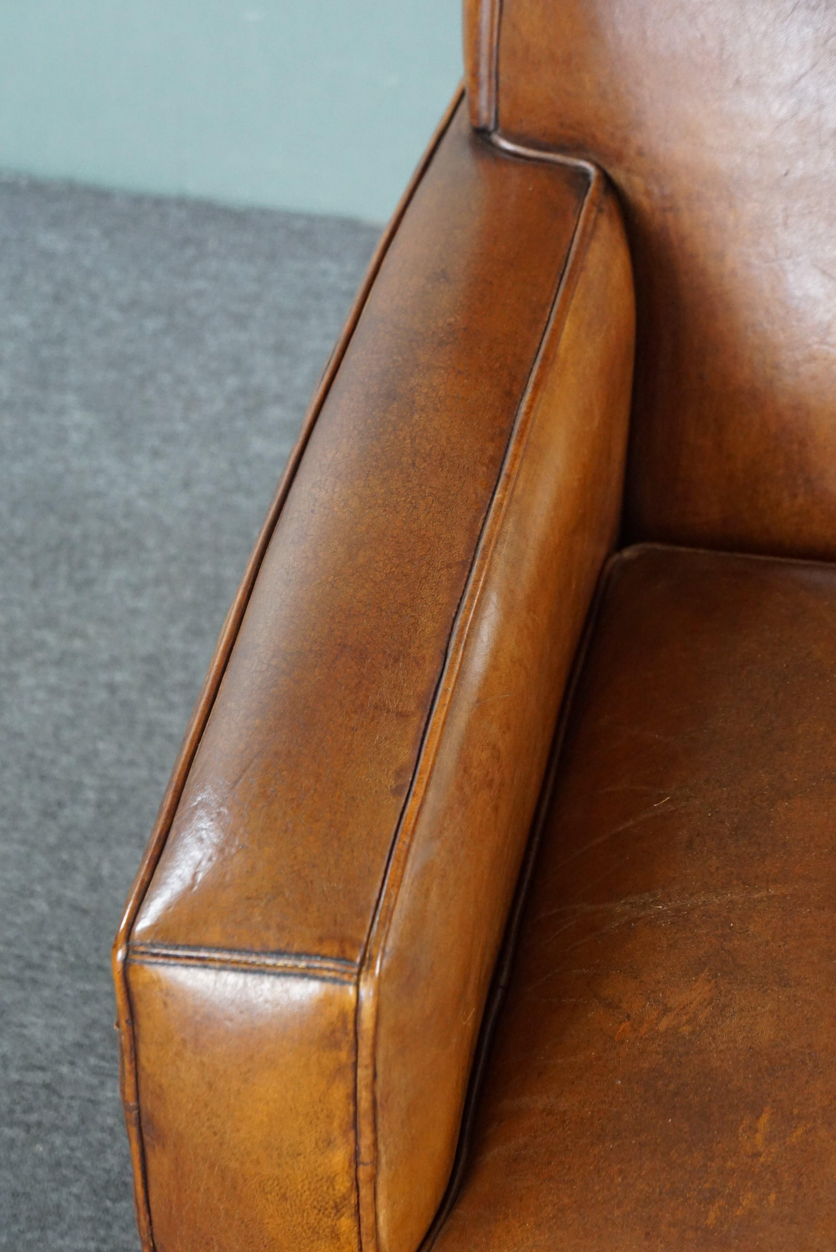 Large cognac-colored sheep leather armchair in good condition with a sleek desig For Sale 2