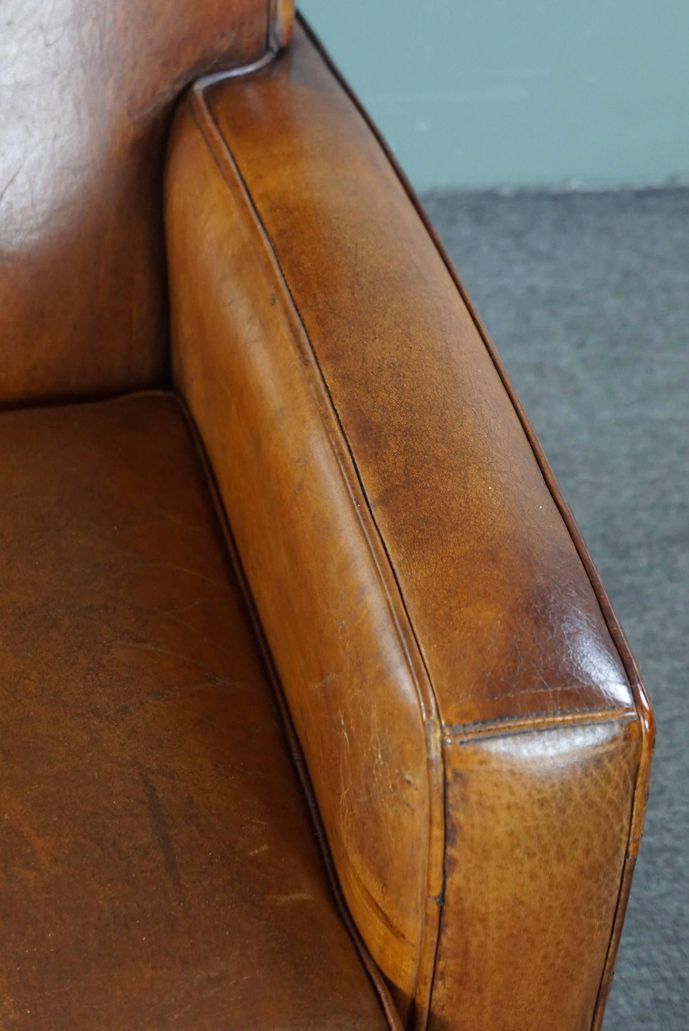 Large cognac-colored sheep leather armchair in good condition with a sleek desig For Sale 3