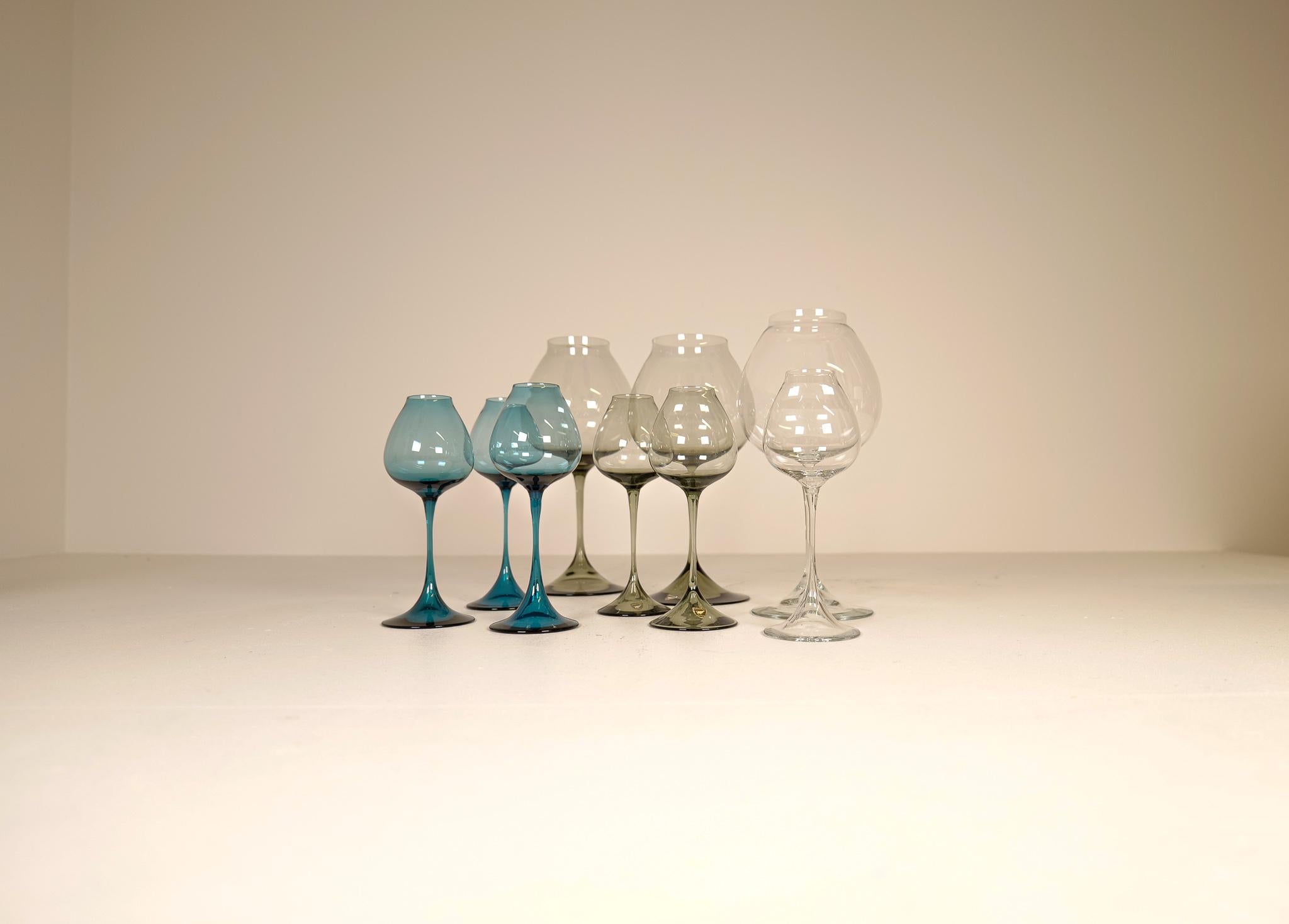 Wonderful collection of 9 tulip glasses in grey tinted blue colored and clear glass design. Manufactured at Orrefors in Sweden and design by Nils Landberg.

Good vintage condition and some are wearing label.

Dimensions: Heights from 31 cm and