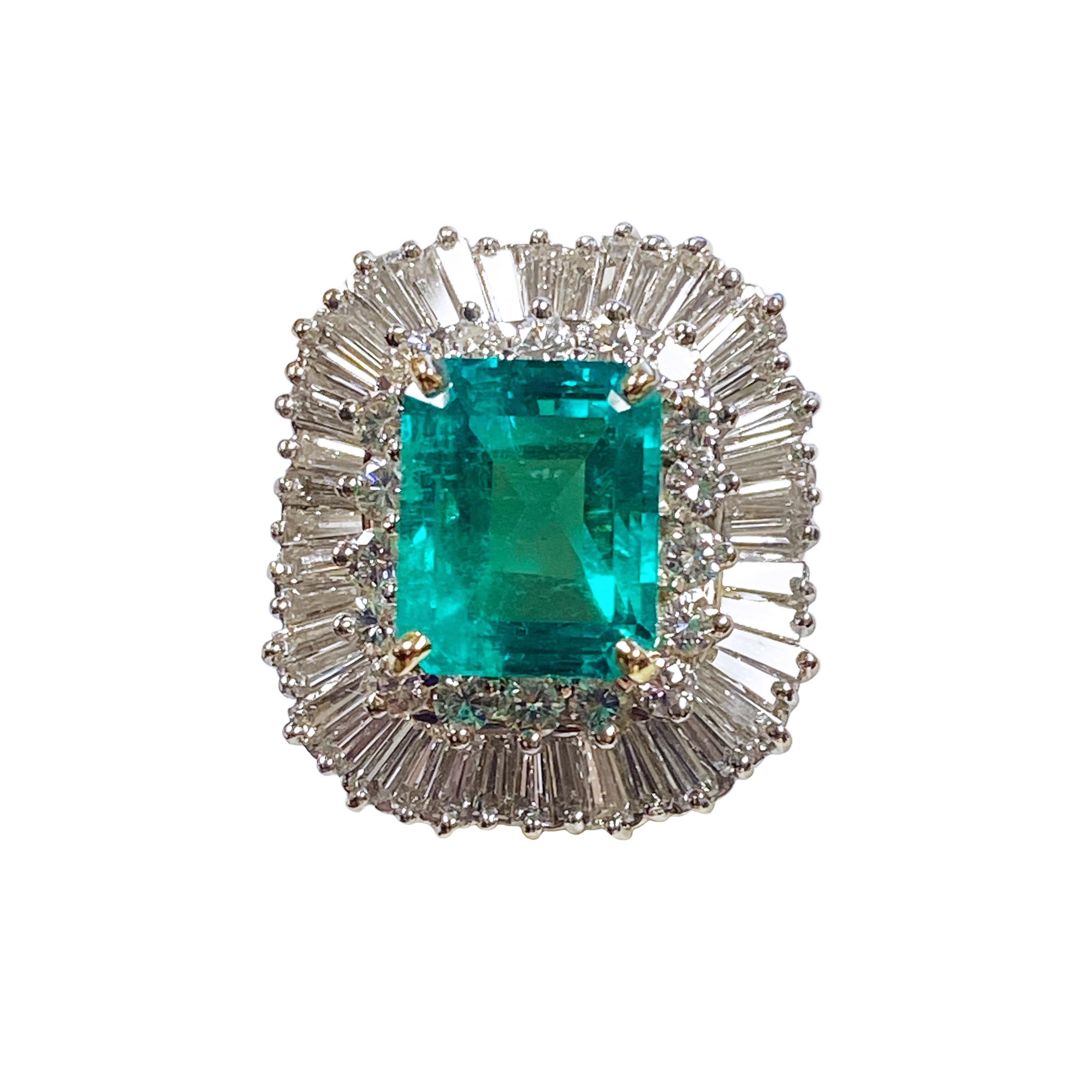 Circa 2000 Large and impressive Emerald and Diamond Ring, hand fabricated in 18k Yellow Gold with an 18k White Gold top section, the top of the ring measures 7/8 X 3/4 inches. Centrally set with a Very Fine Color step cut Emerald of Colombian origin