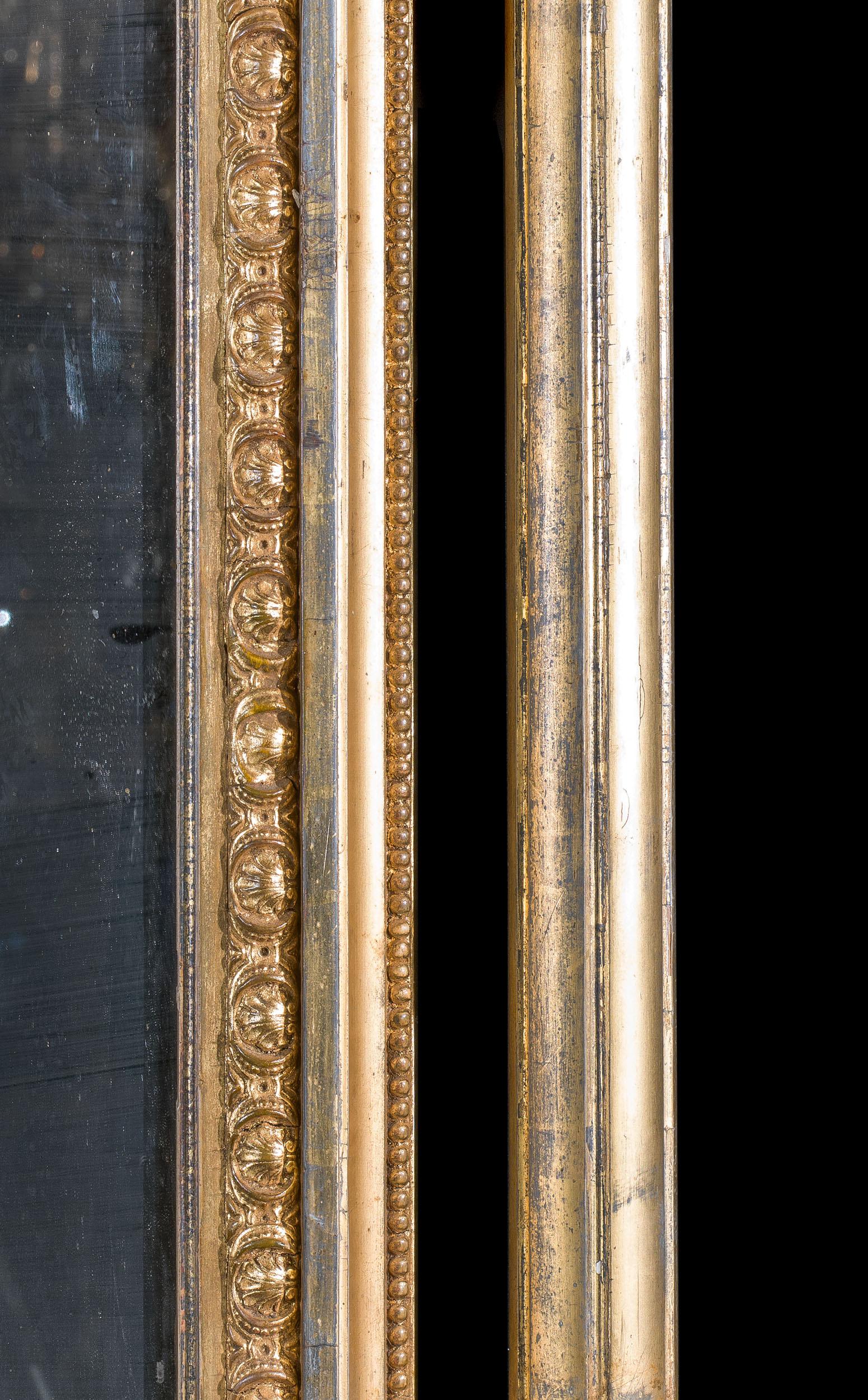 A large and fine gilt gesso overmantel mirror with an arched pediment centred by a floral rosette and laurel sprays. This is supported by two fine columns. This mirror is of excellent quality, with a sturdy panelled back.

English, c.1880.
