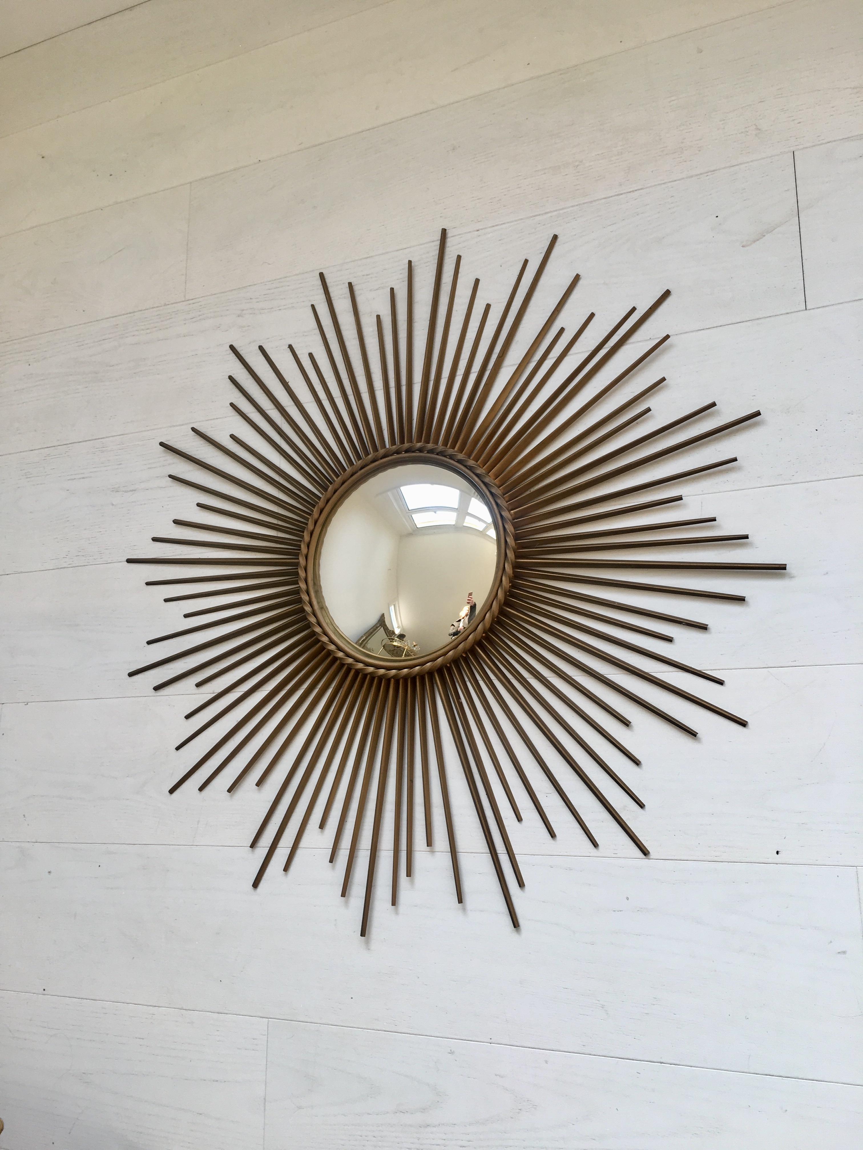 Large original Chaty Vallauris sunburst mirror with convex glass

Great shape, with all the spikes in good order

Some age related markings to the spikes as per images 

Stamped on back

Measure: 82.5cm across, central mirror is