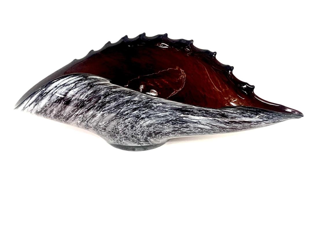 Larger cased amethyst and grey large shell form art glass bowl with scalloped rim along the back and smooth edge across the front.

Dimensions: 17 1/4