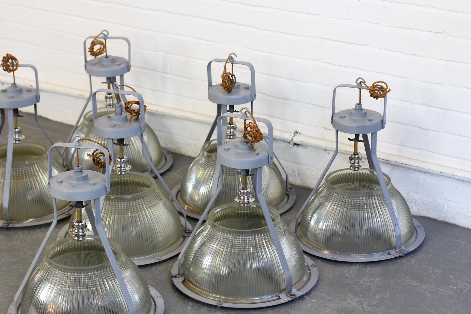 Large concord factory lights, circa 1950s.

- Price is per light (7 available)
- Heavy prismatic Holophane glass
- Cast steel tops
- Takes E27 fitting bulbs
- Comes with steel suspension chain and ceiling hooks
- Salvaged from the Concord