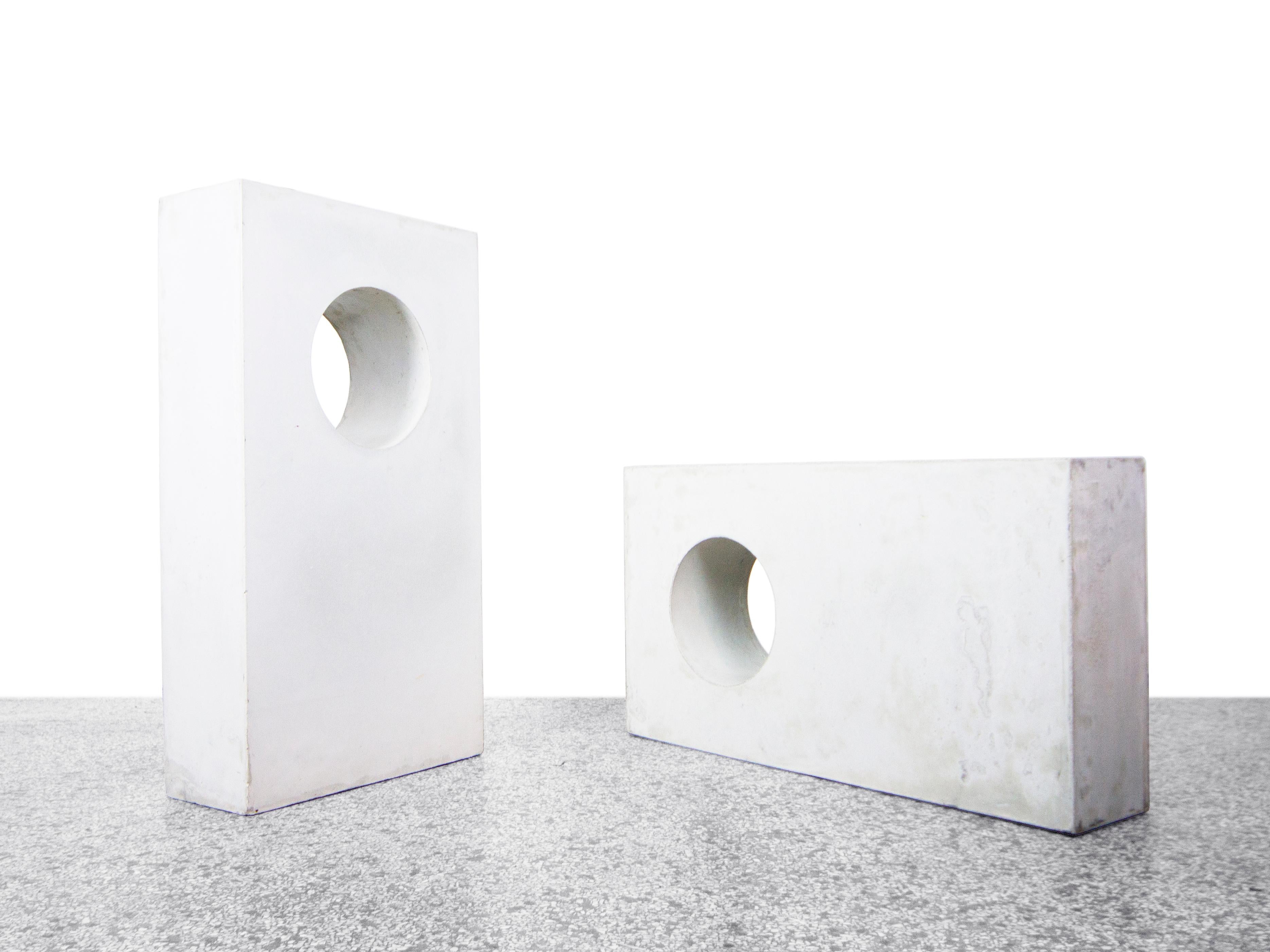 Pair of large concrete architectural forms. Can be used as table bases to create a variety of table sizes or as standalone sculptural elements. 

Dimensions: 36