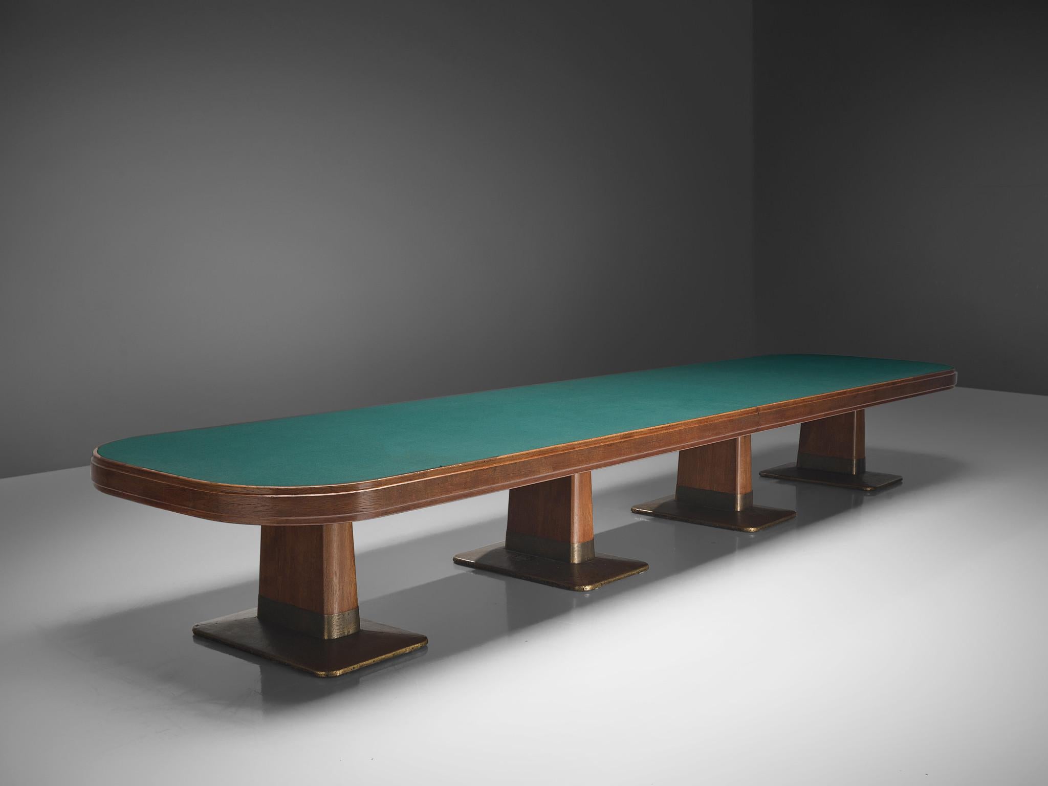 Conference table, oak, brass, felt, plexiglass Germany, 1950s.

A grandiose conference table consisting of two parts that due its width of 19ft could easily function as a conference table. The rectangular-shaped tabletop with curved edges is covered