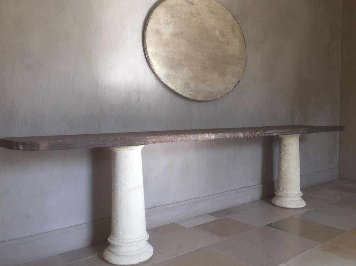 A large console with a one slab 17th century oak top on 18th century sandstone columns. These 2 pieces have been married by our workshop. We often wait until we come across the perfect top for columns or trestles we found earlier... or vice versa.