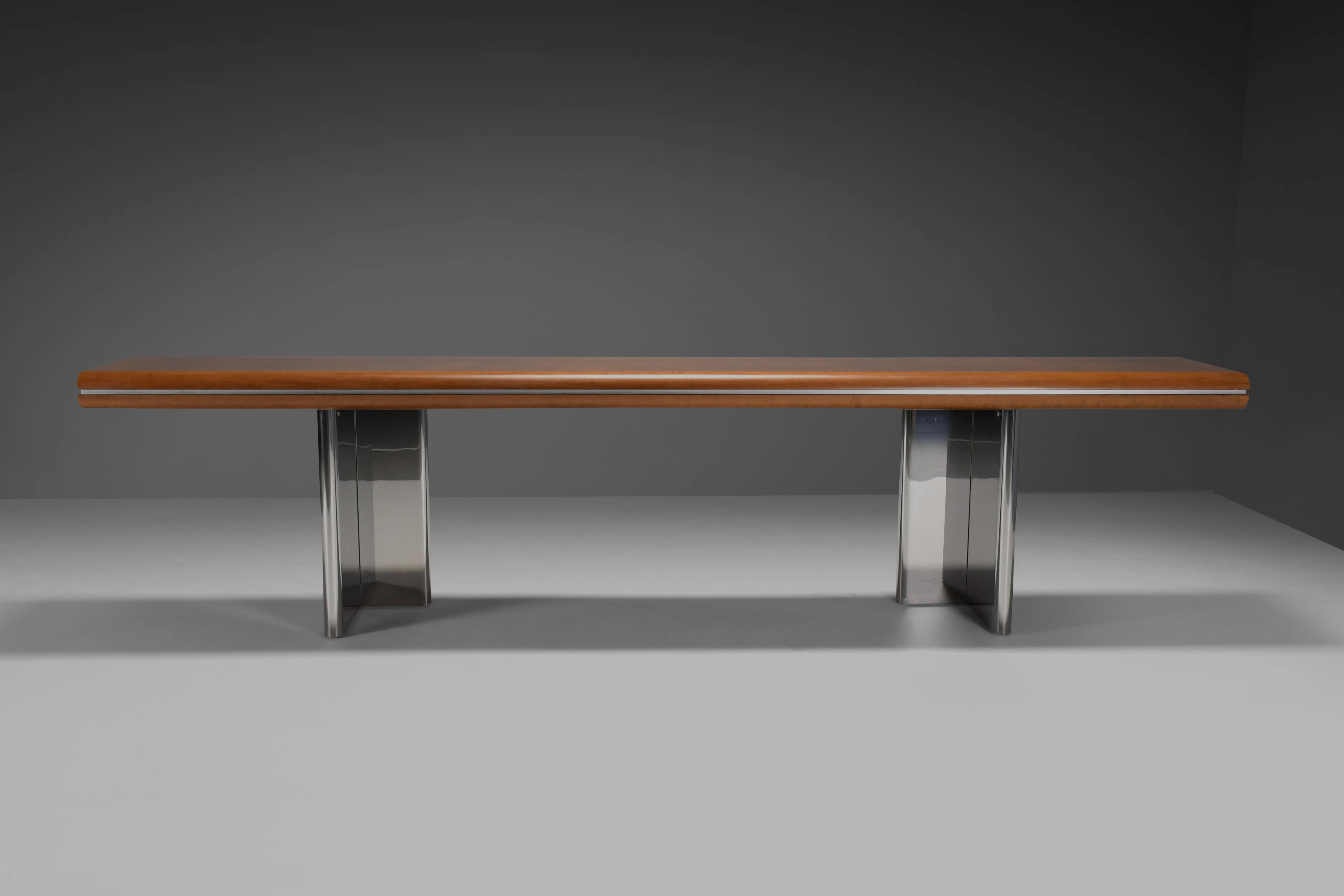 Beautiful console table in very good condition.

Designed by Hans von Klier 

Manufactured by Gruppo Skipper Italy in the 1970s 

The top is made from beautiful massive walnut which is separated by a chrome metal line.

The two L-shaped legs are