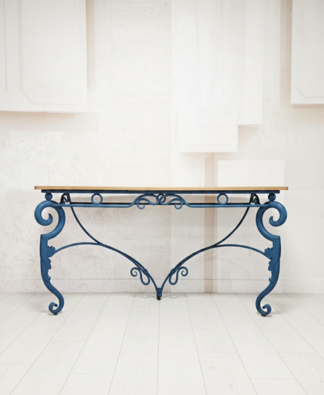This large vintage blue metal console table is an antique piece dating back to the 1940/50s, featuring a French style with intricate carvings. The table is fully assembled and made of wood and metal materials sourced from France, making it a unique