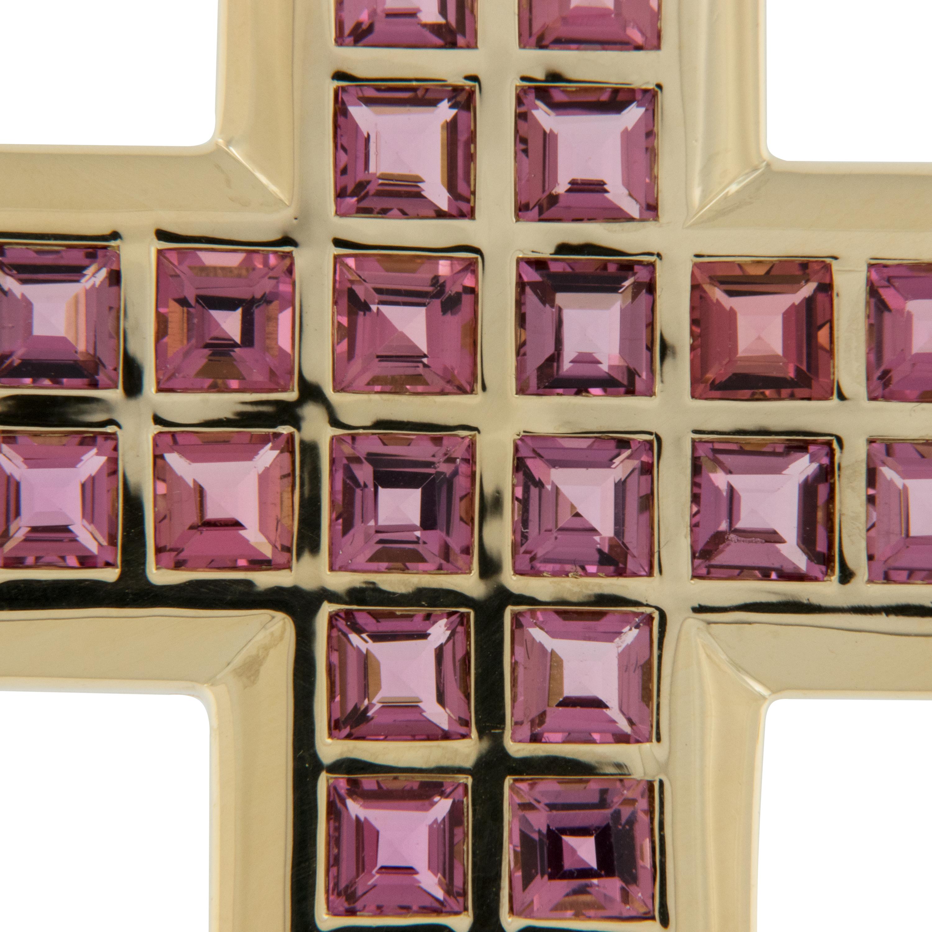 This classic shaped cross with a contemporary feel is stunning in 18 karat yellow gold. Accented with 5.28 Cttw. of square cut pink tourmalines which compliment the hue of the gold perfectly. Tourmalines are  considered a physical bridge to the
