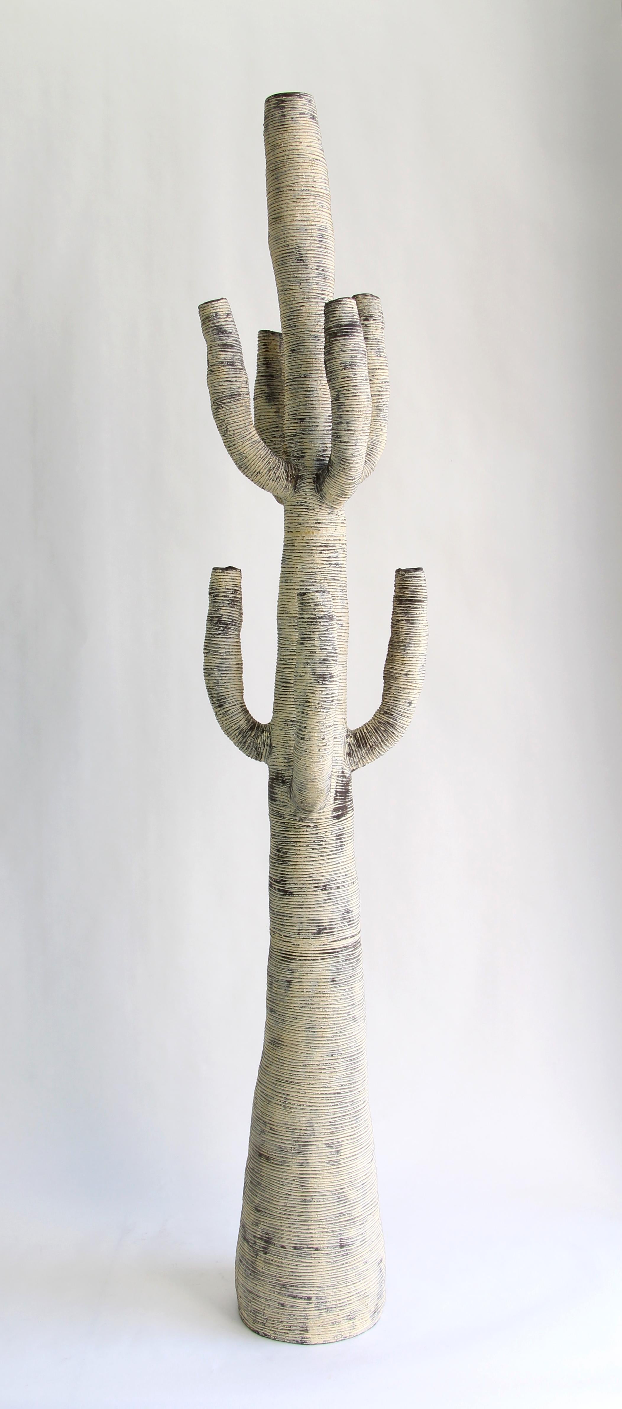 Large black and white stoneware cactus created by Julie Bergeron. The organic forms and rich textures express the intense beauty of nature in all its irregularity. Rich variations in tone, from the deep undertones of the brown/black stoneware to the