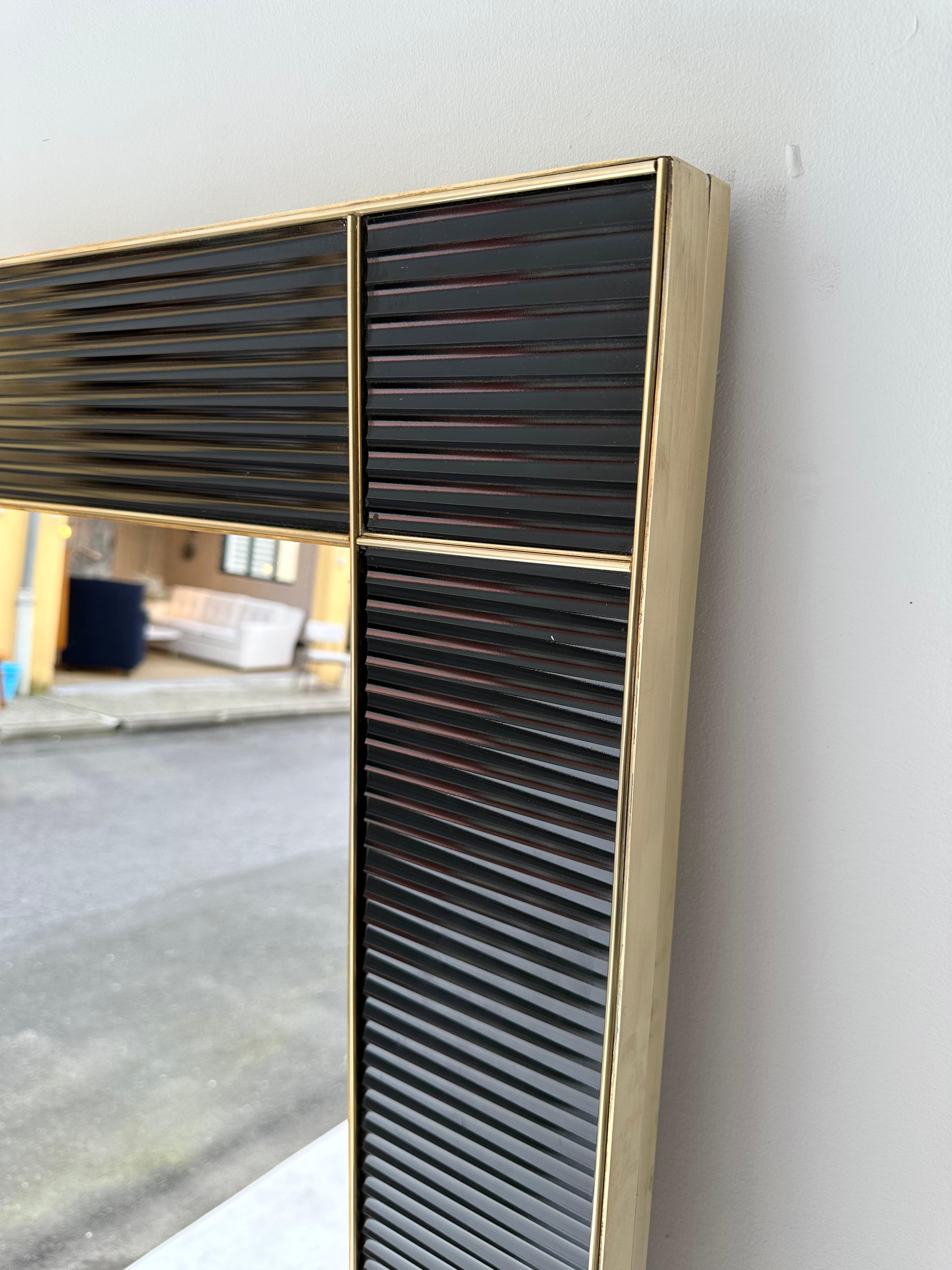Wall mirror full brass and black fluted Murano glass. Small artisanal production from an italian workshop. Can be hang horizontally or vertically.