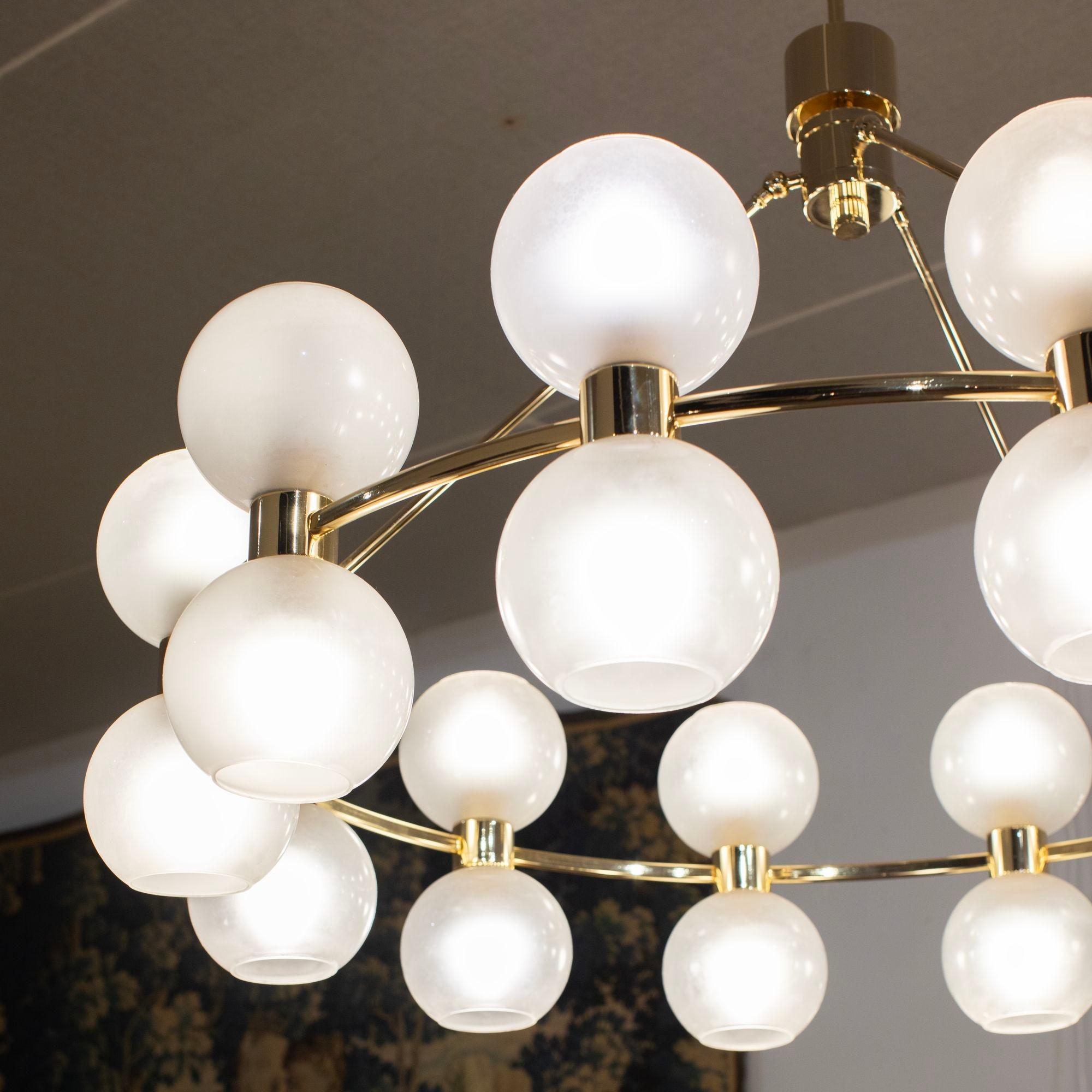 Impressive modern Italian chandelier in glass and brass.With twenty-four opaque glass balls to the surround. Perfect for hanging above a large dining table or in a lounge area.