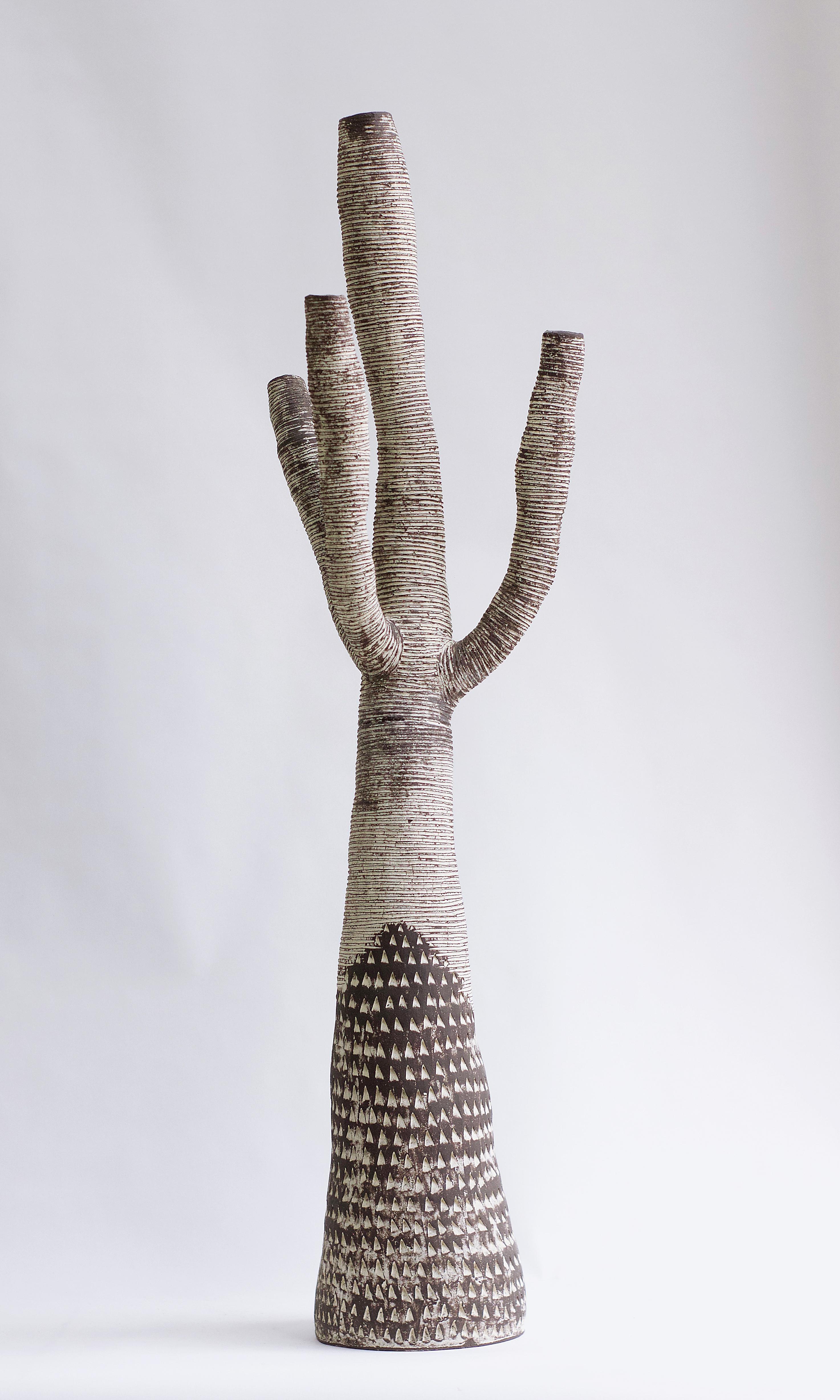 Large contemporary tree sculpture hand-built of black ceramic and accented in white slip. Triangular motifs adorn the base. The organic forms and rich textures express the intense beauty of nature. Rich variations of black and white vibrate with the