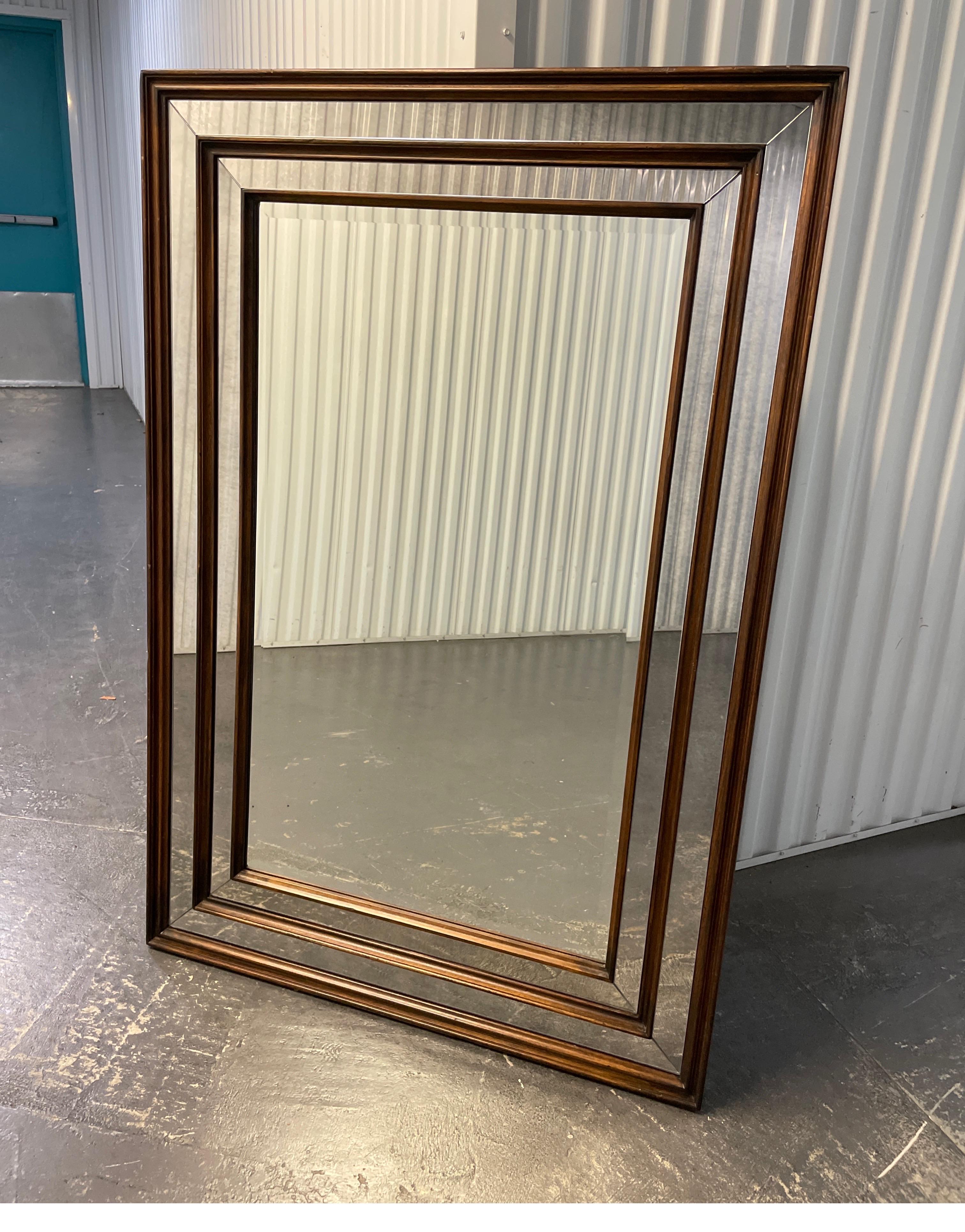 Vintage large triple wood framed contemporary beveled mirror in a dark walnut color.